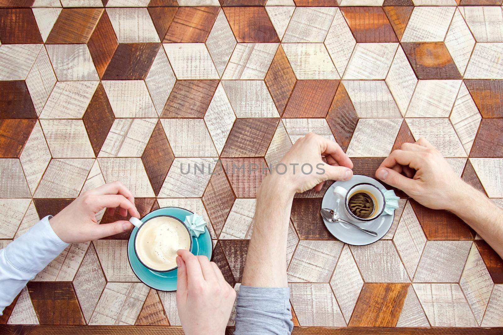Top view of couple hands whith coffee on a table