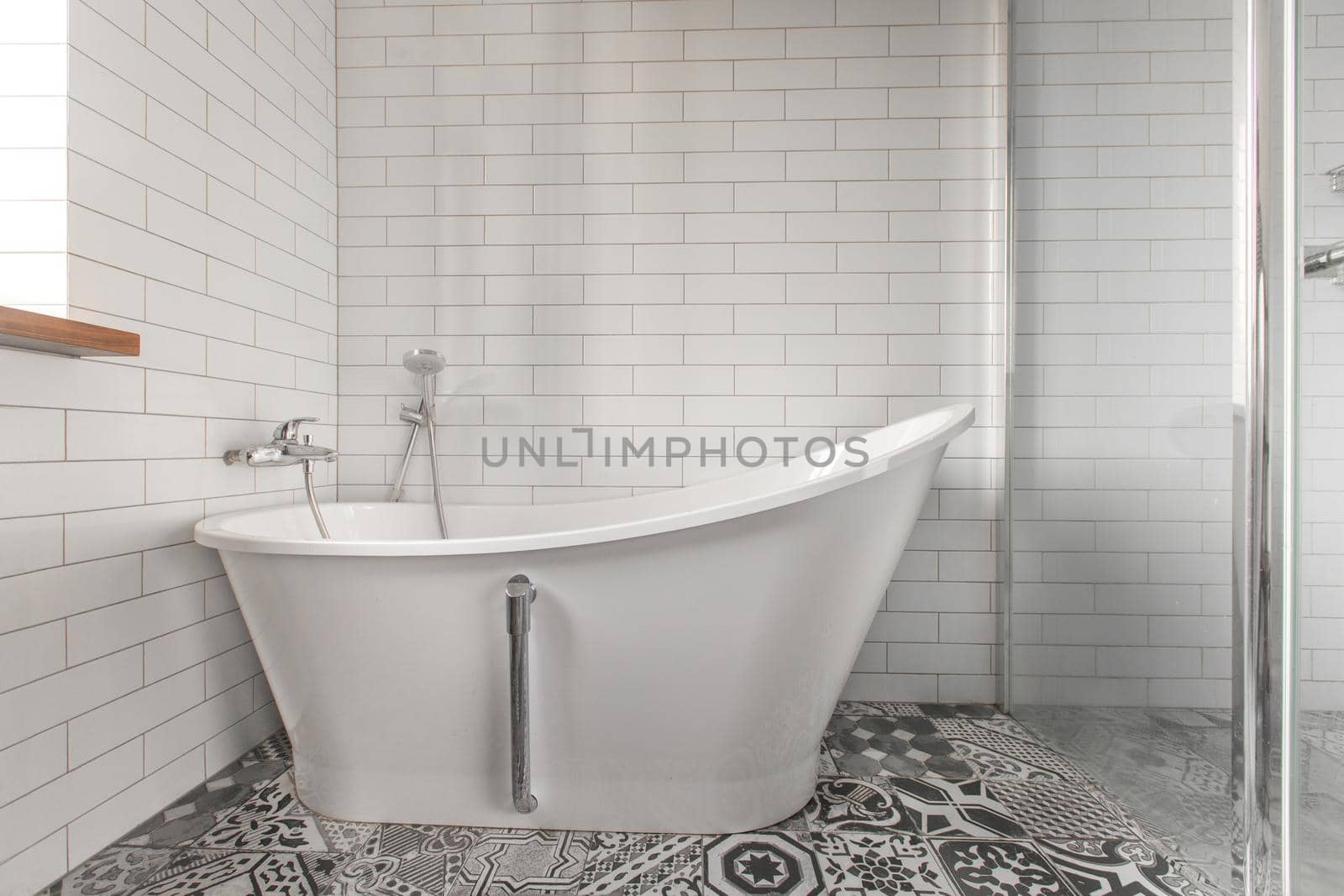 White bathroom on a tiled wall background Classic bathtub