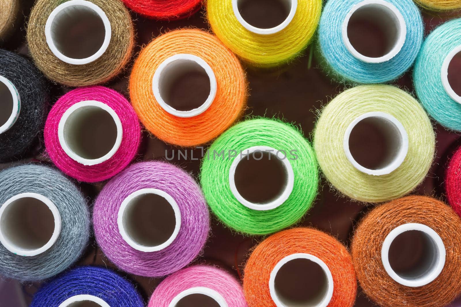 A lot of colorful sewing threads. Abstract background. Top view, closeup. by marketlan