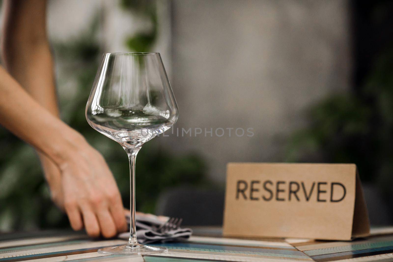 Hands serving reserved table by Demkat
