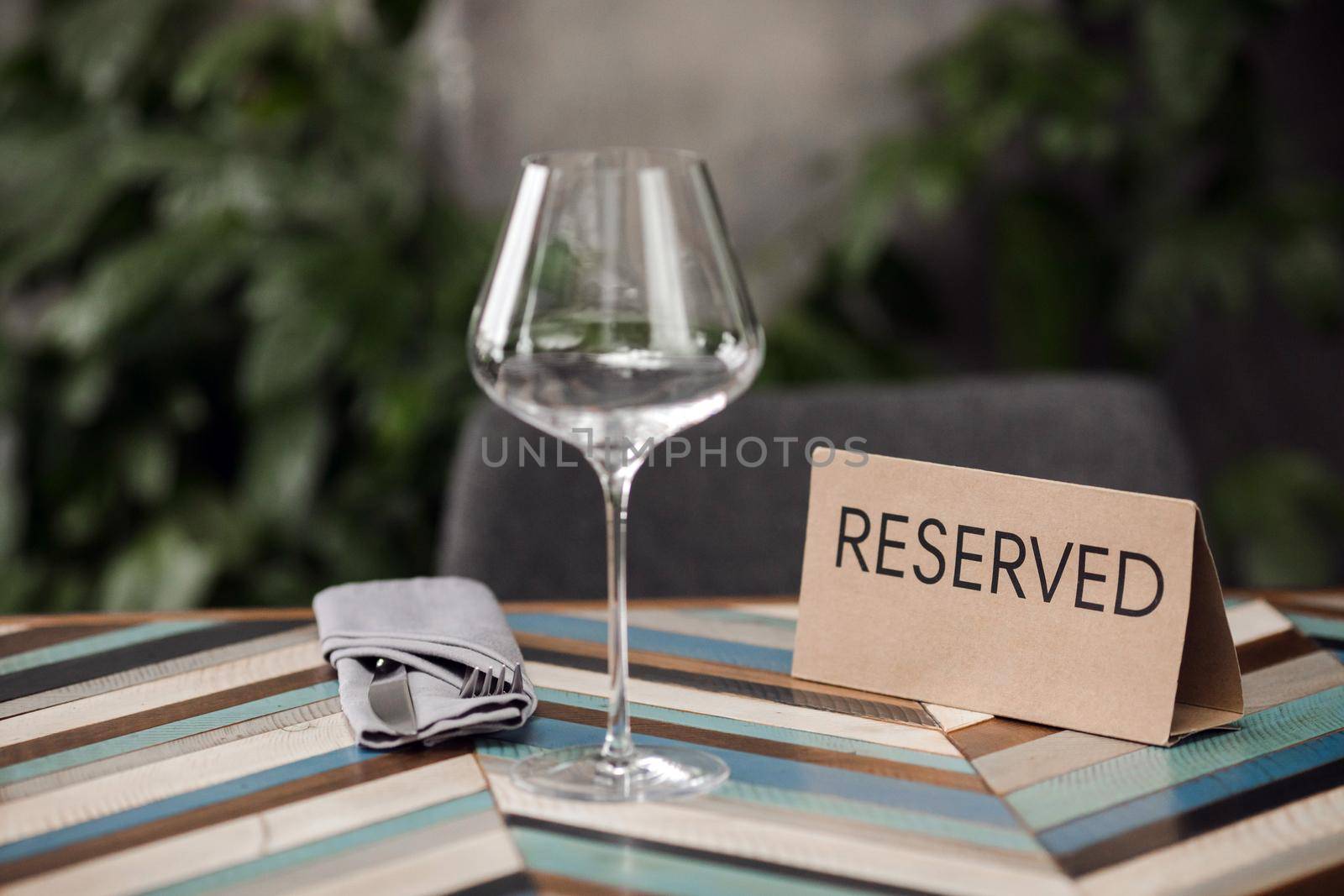 Reserved table with empty glass and cutlery in the cafe