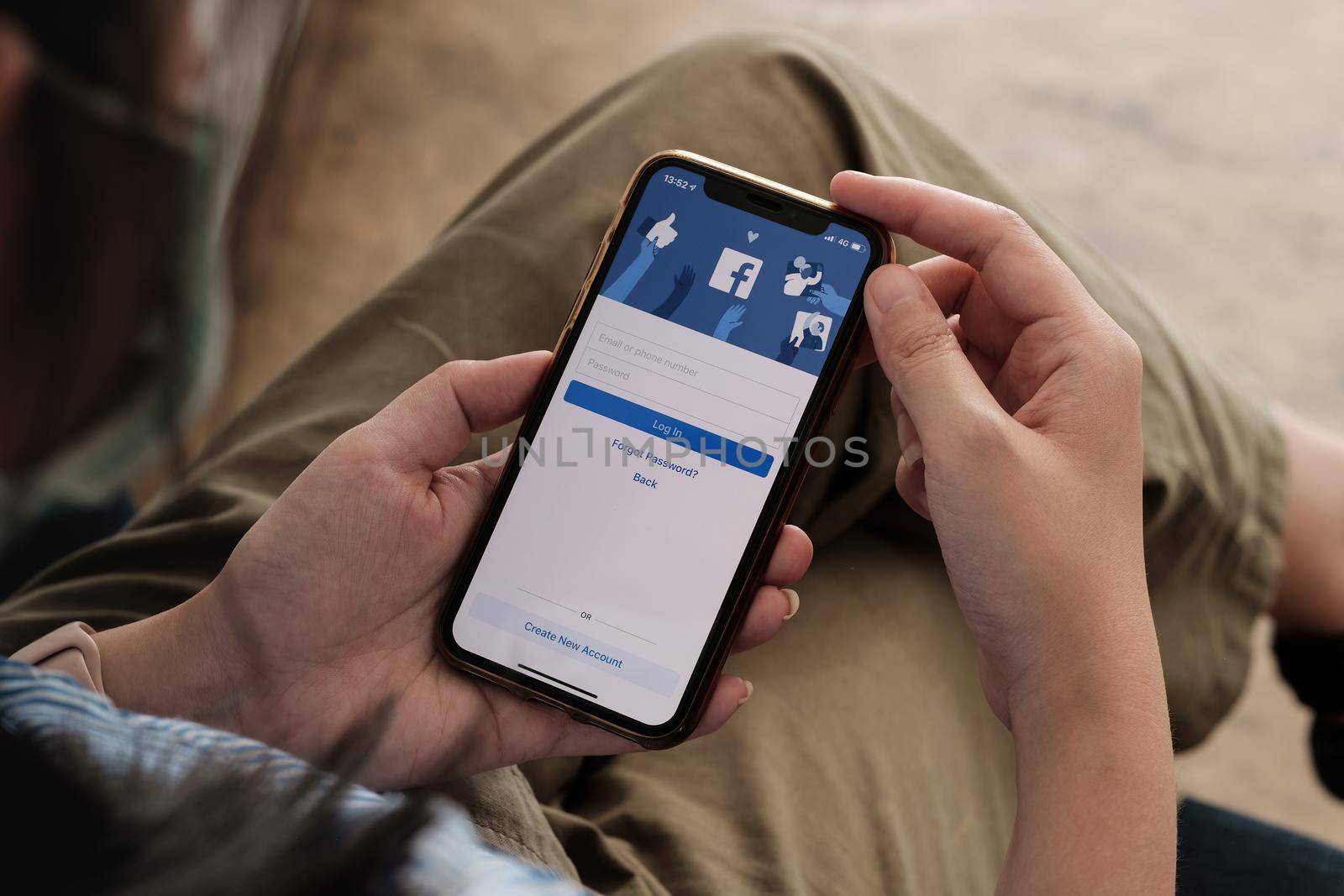 CHIANG MAI, THAILAND - NOV 7, 2021: Facebook social media app logo on log-in, sign-up registration page on mobile app screen on iPhone X in person's hand working on e-commerce shopping business