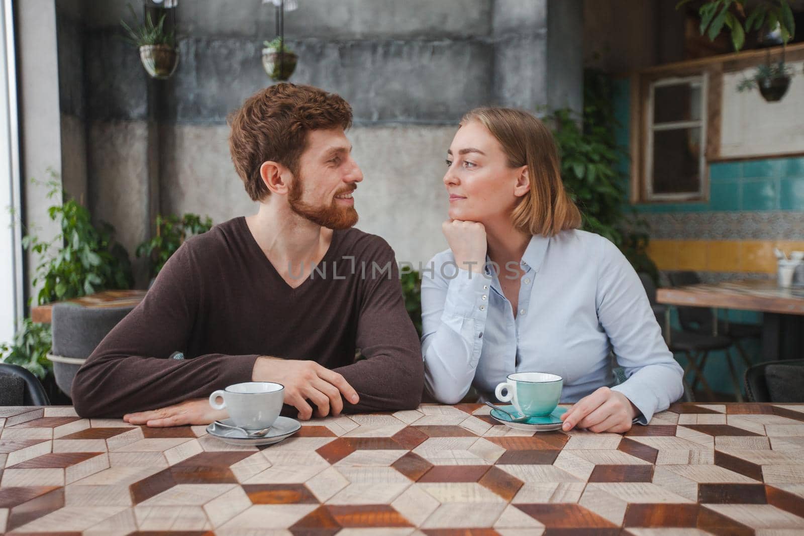 Cheerful couple having coffee by Demkat