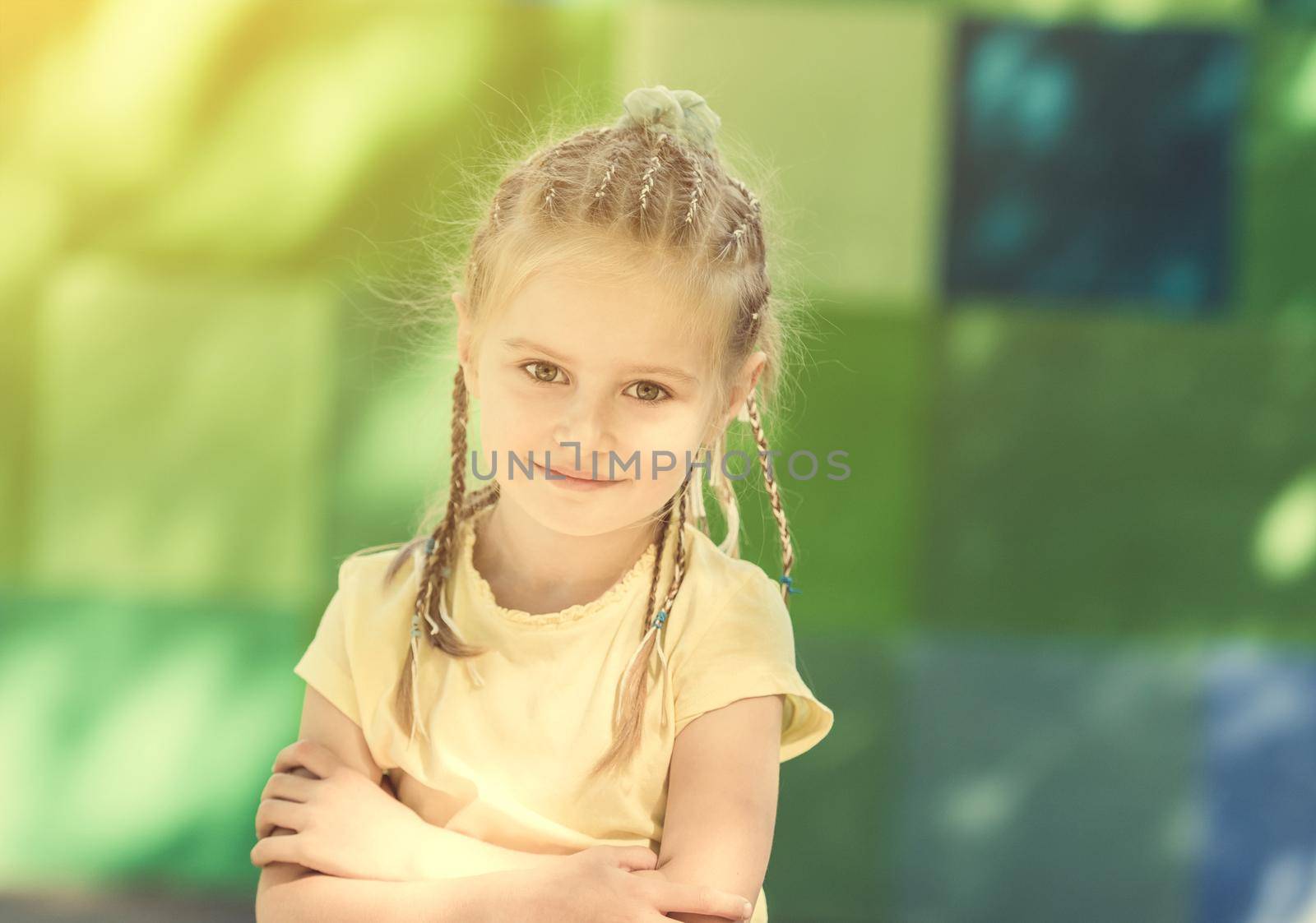 cute little girl smiling in the morning park. blurred background