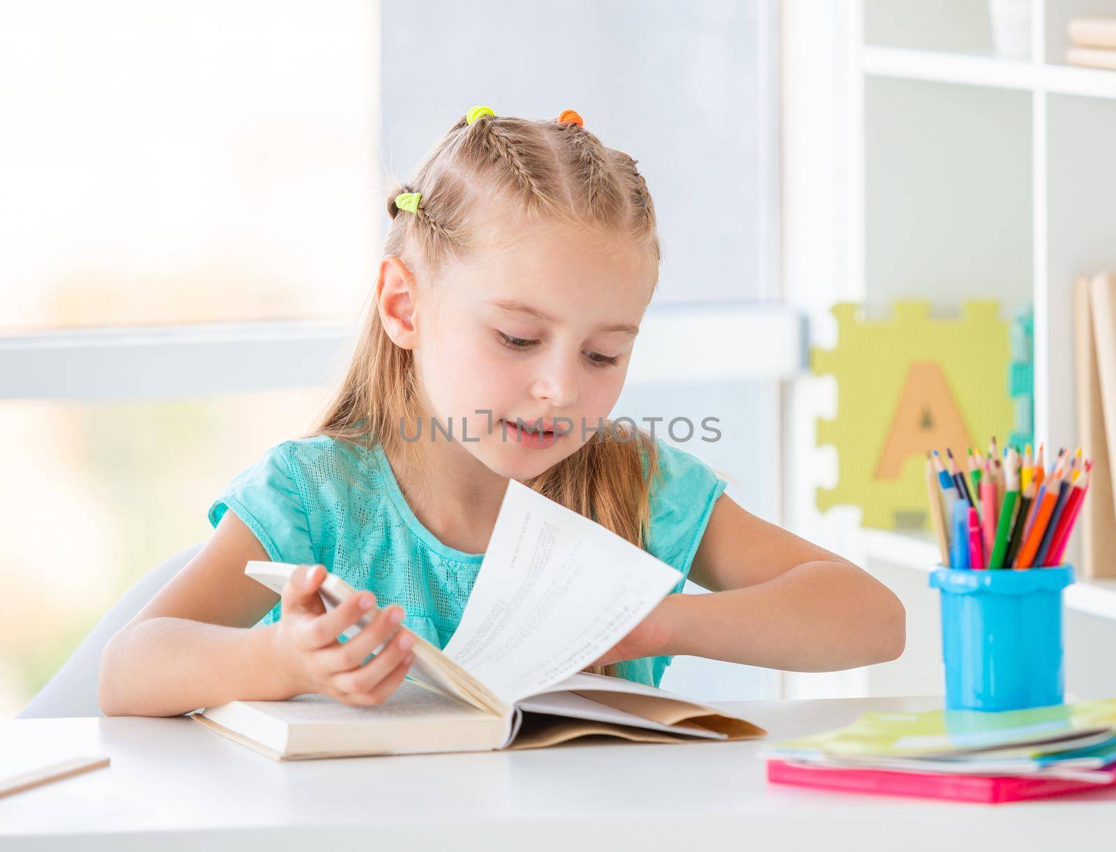School kid with a book looking for proper page
