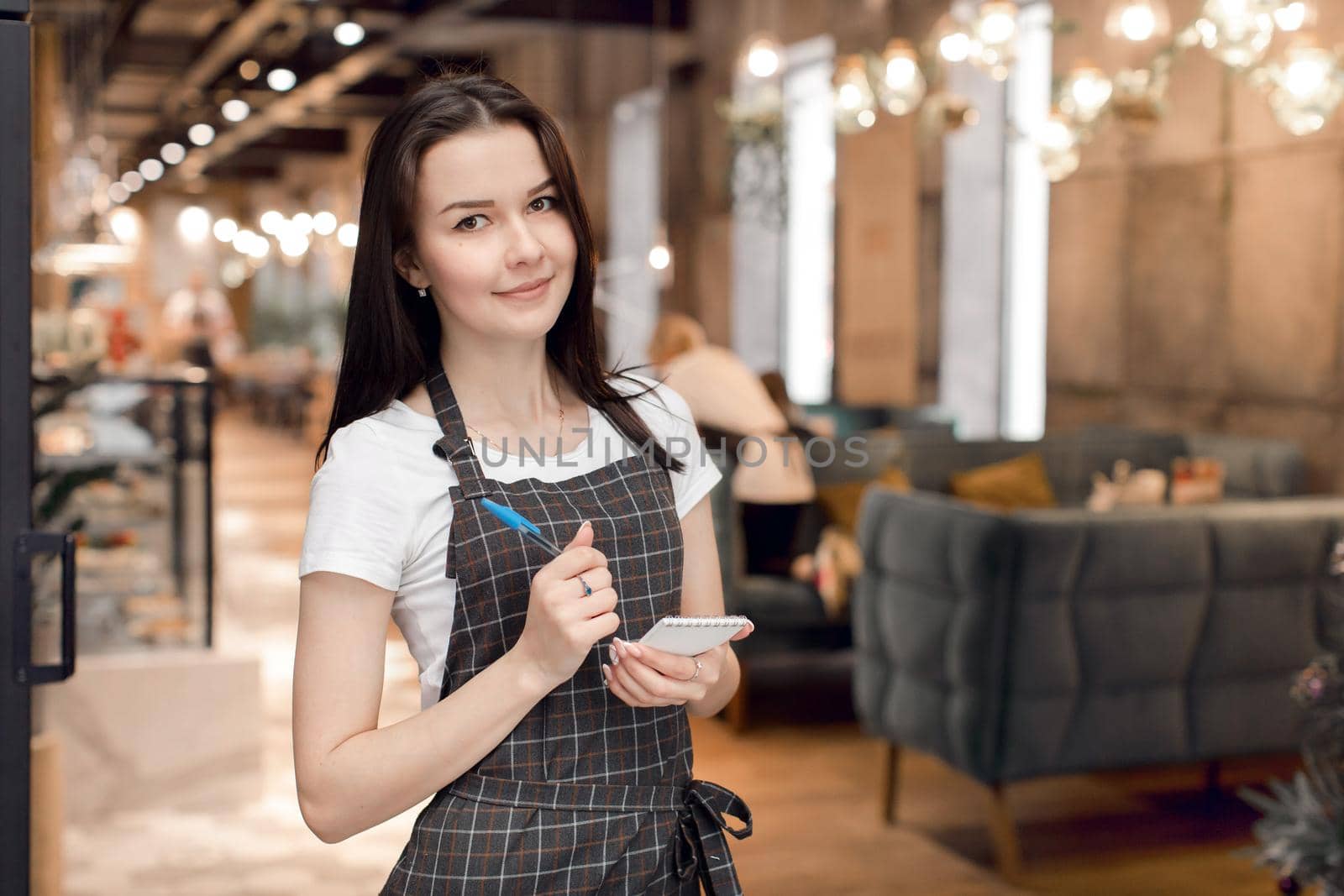 The waitress writes the order in a notepad