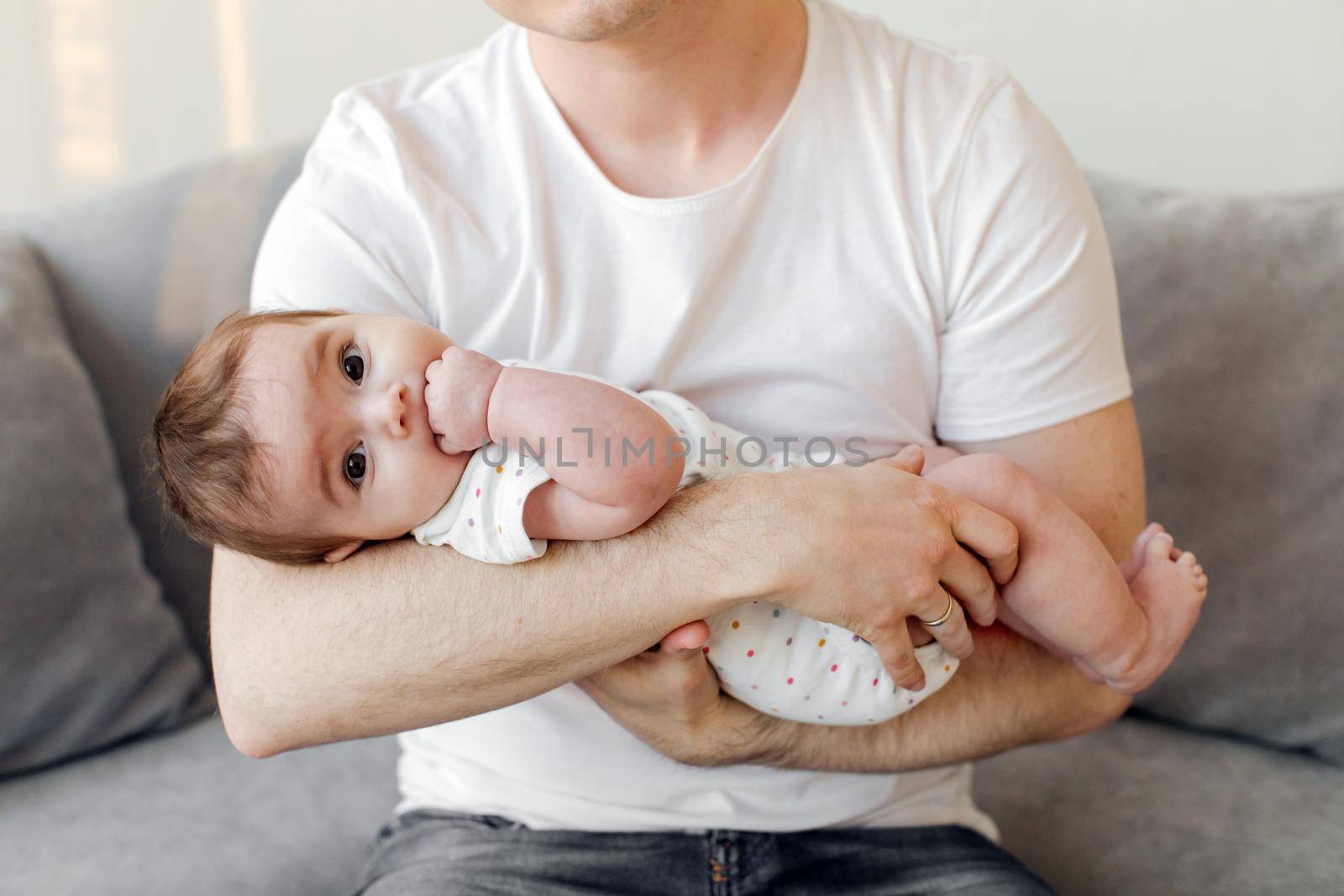Crop father holding baby by Demkat