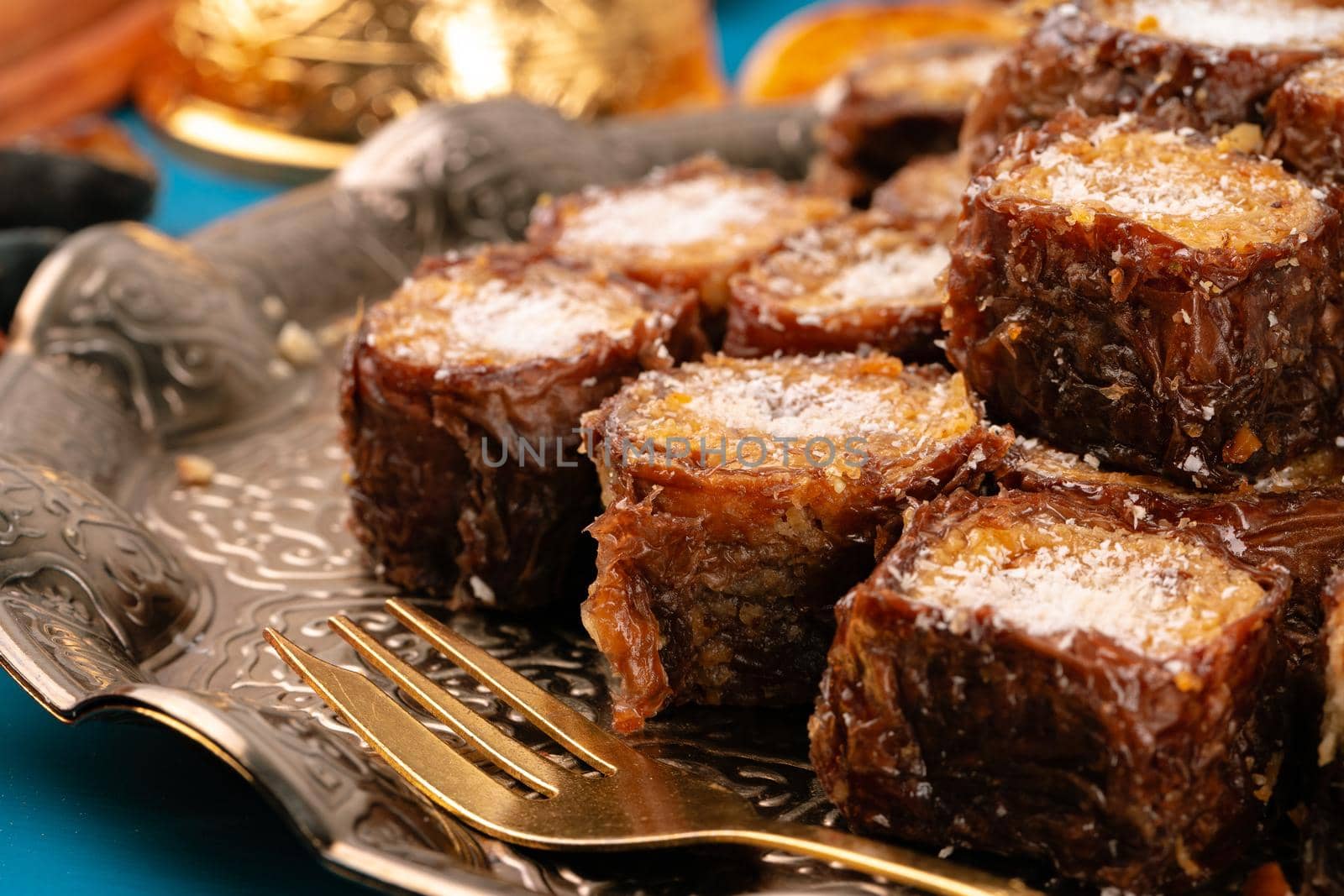 Turkish delight dessert on traditional tableware on dark blue table, close up