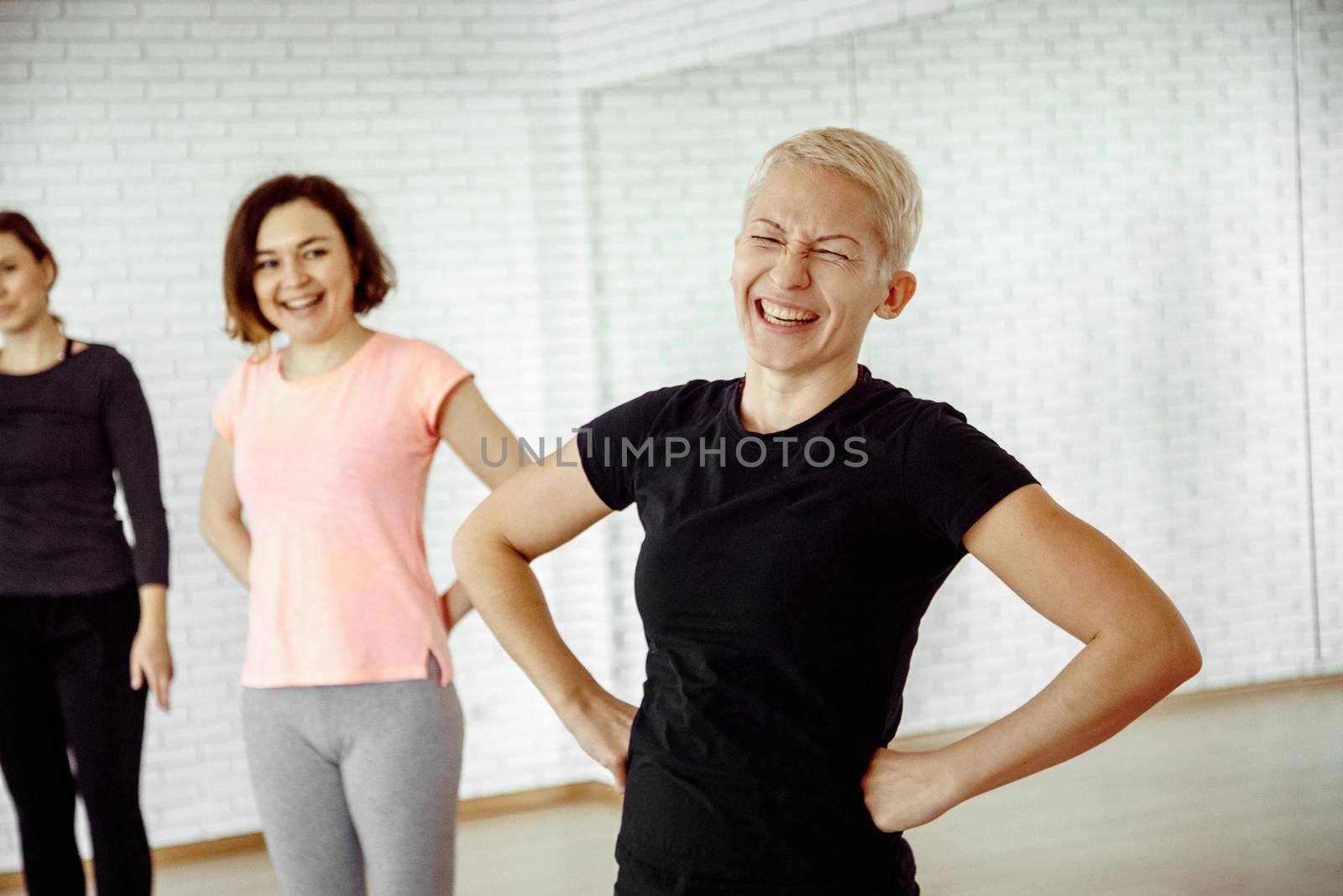 A woman laughs in the gym by Demkat