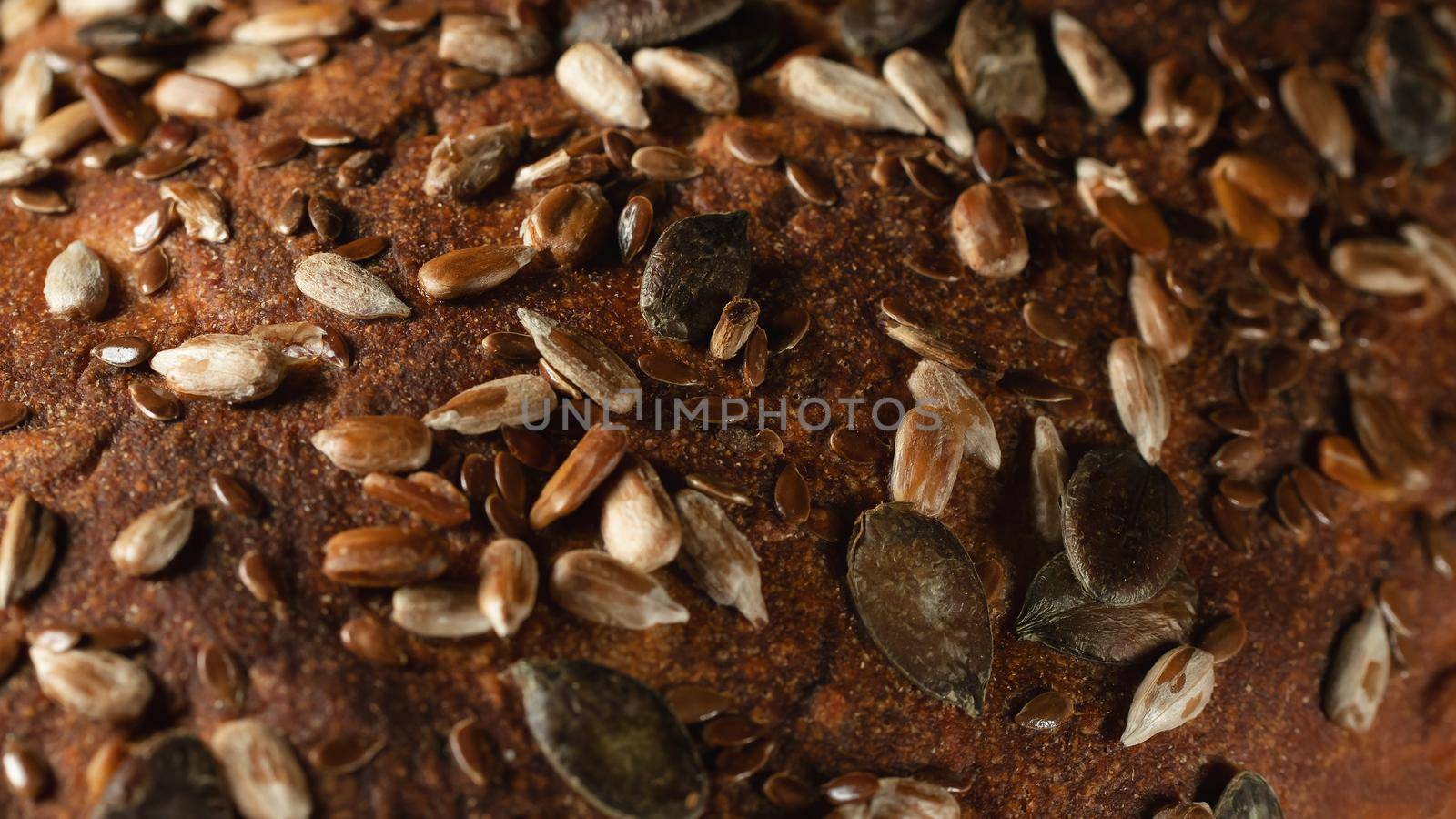 Close-up surface of homemade whole grain bread, food background, texture.