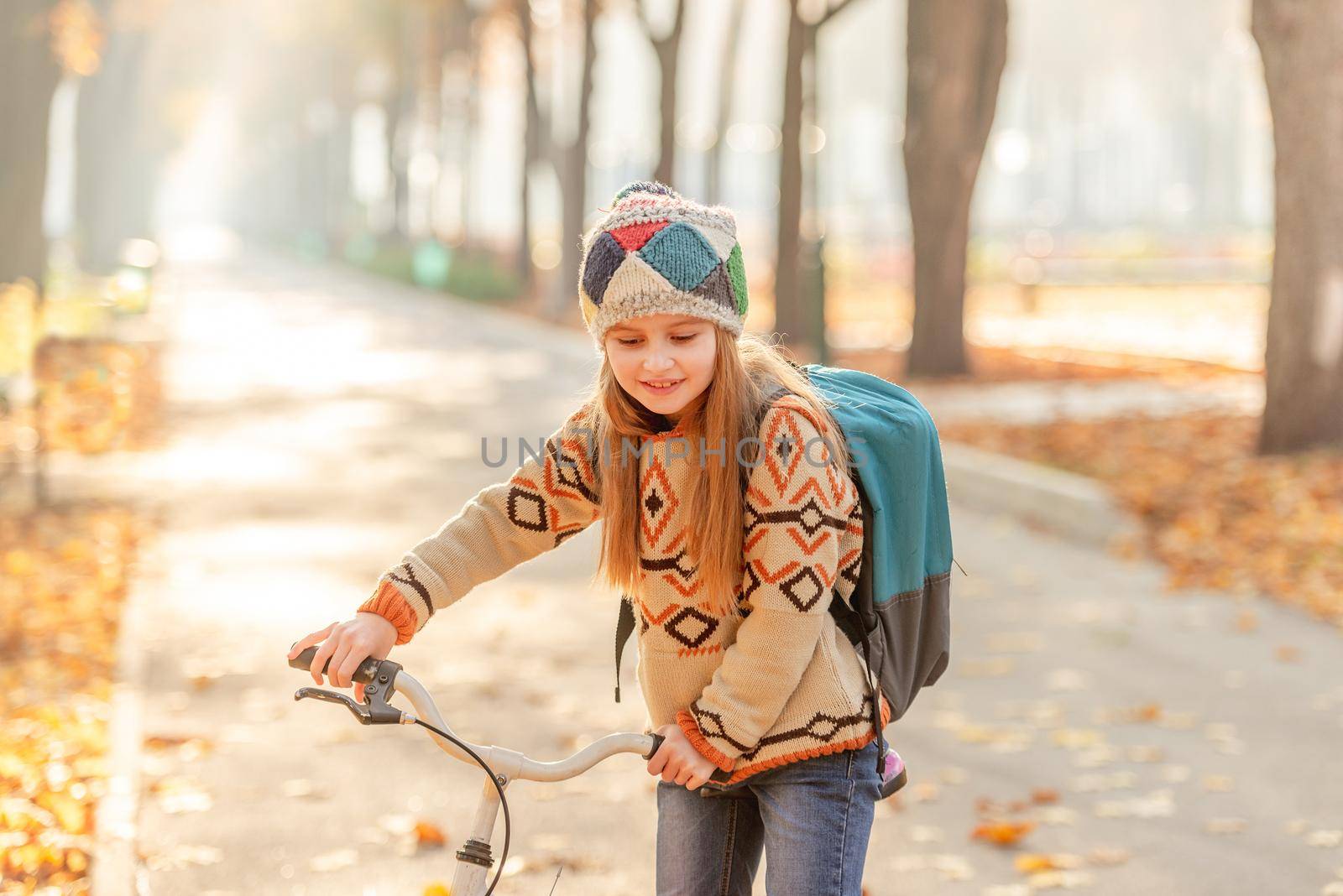 Bicycle girl with backpack riding to school