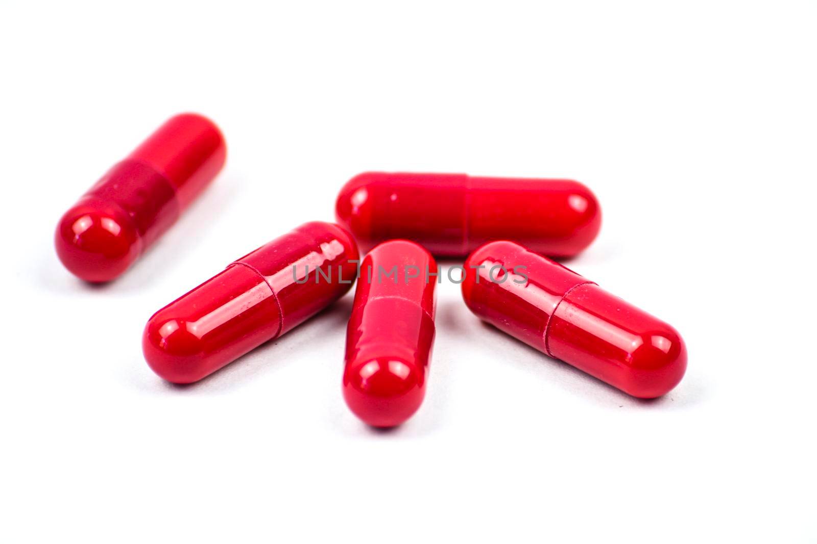 Red pills to treat Covid on white background