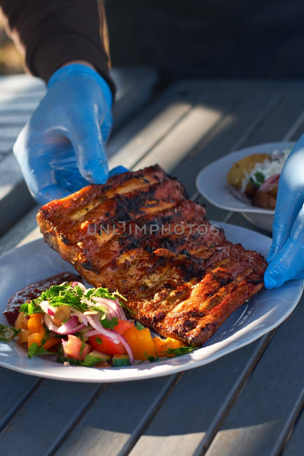 Chef cooked BBQ ribs sliced with hot honey and chili marinade, street food