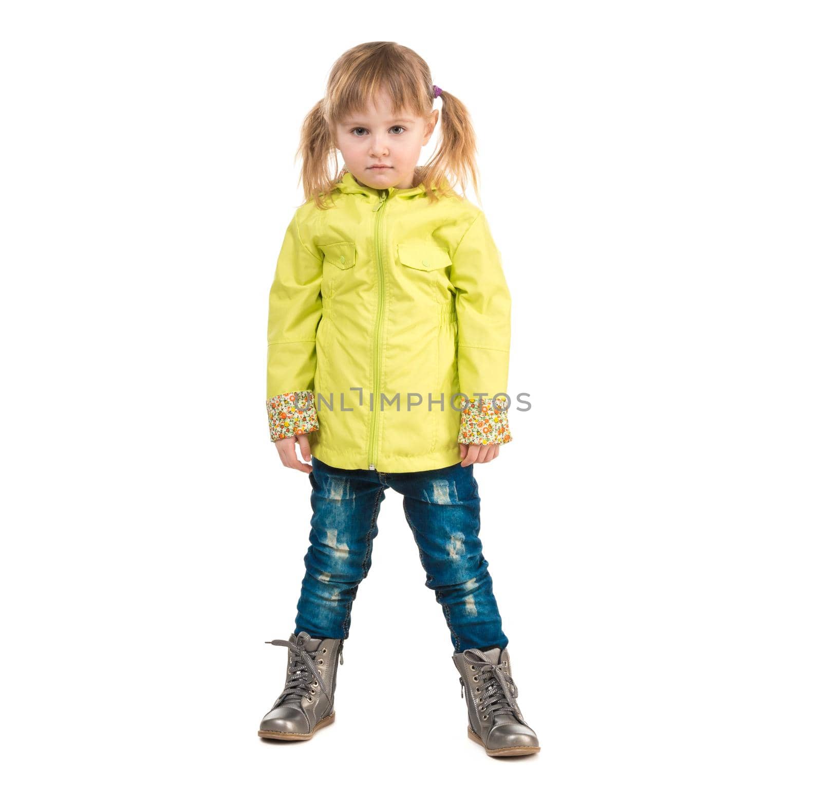 serious little girl in yellow coat isolated on white background