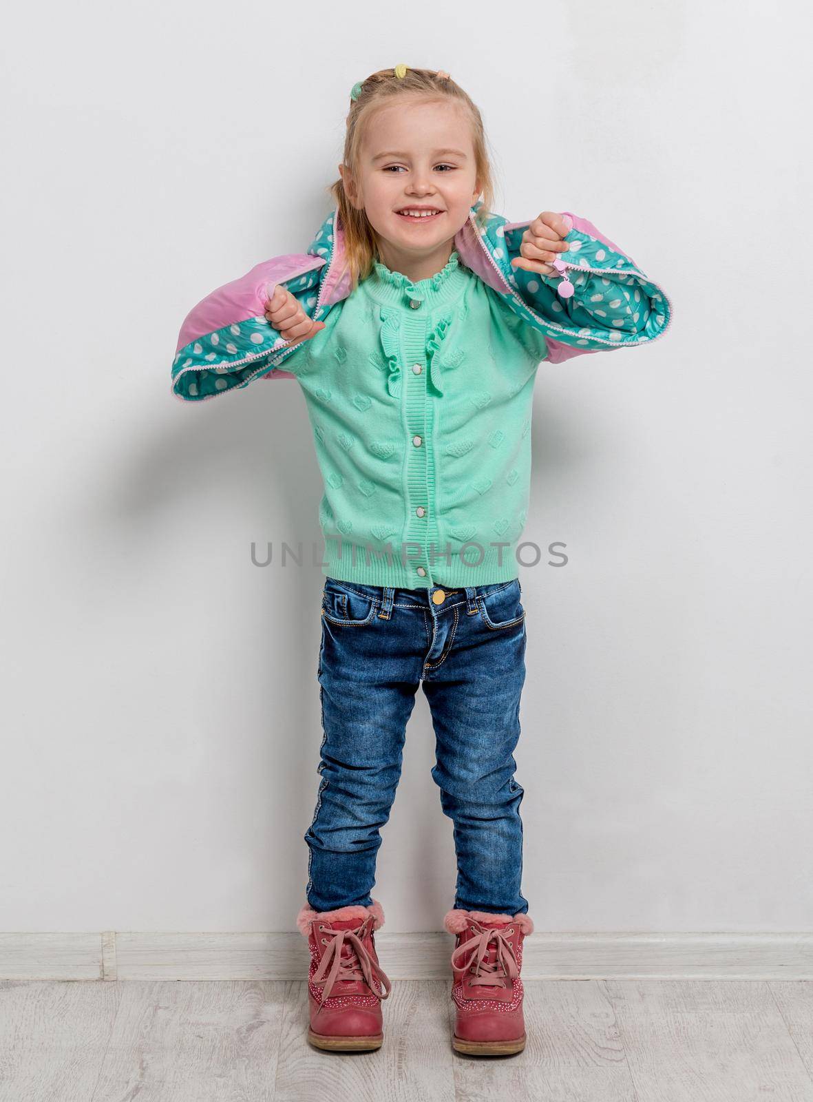 cheerful little girl in turquoise sweater with