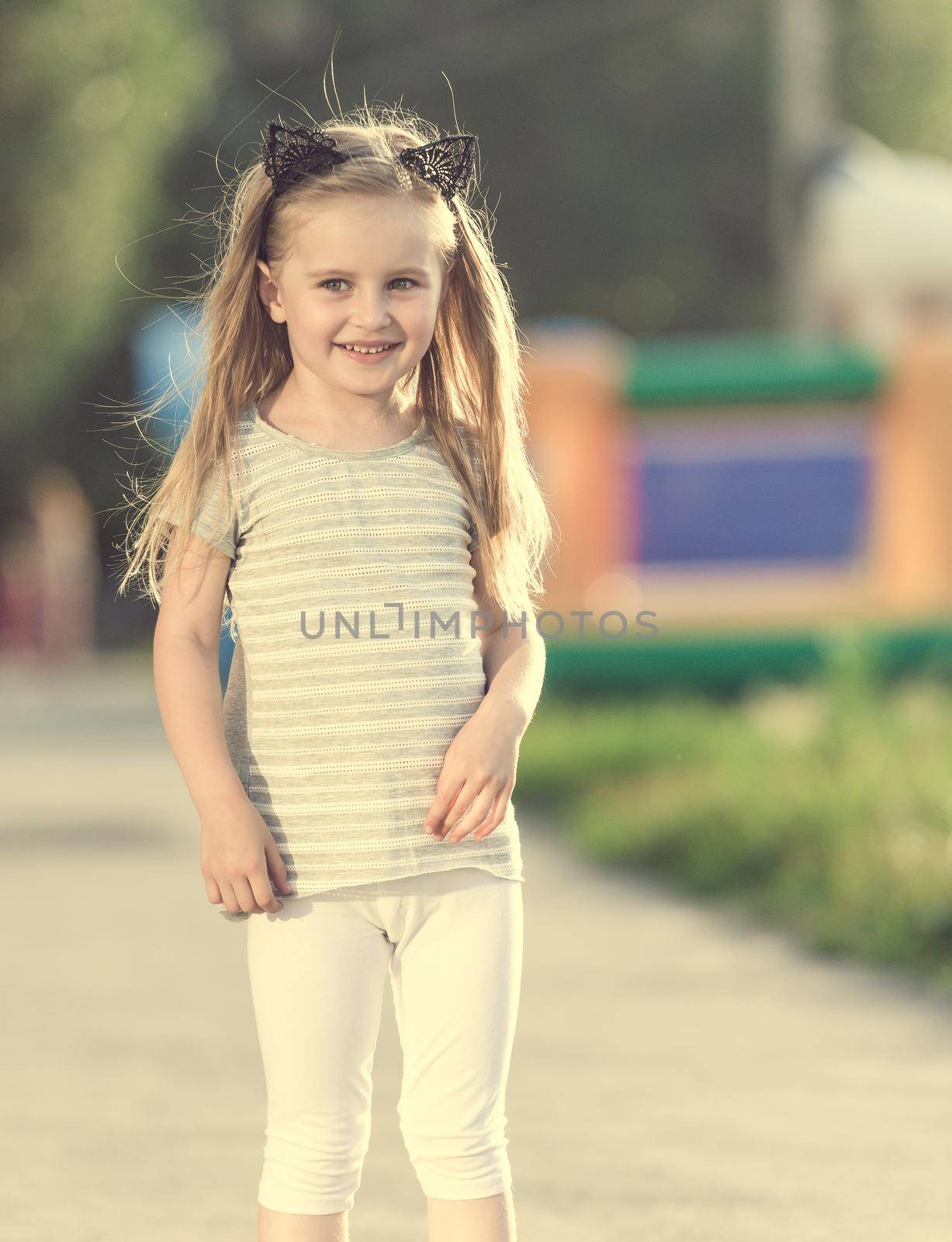Little happy girl walking on the street
