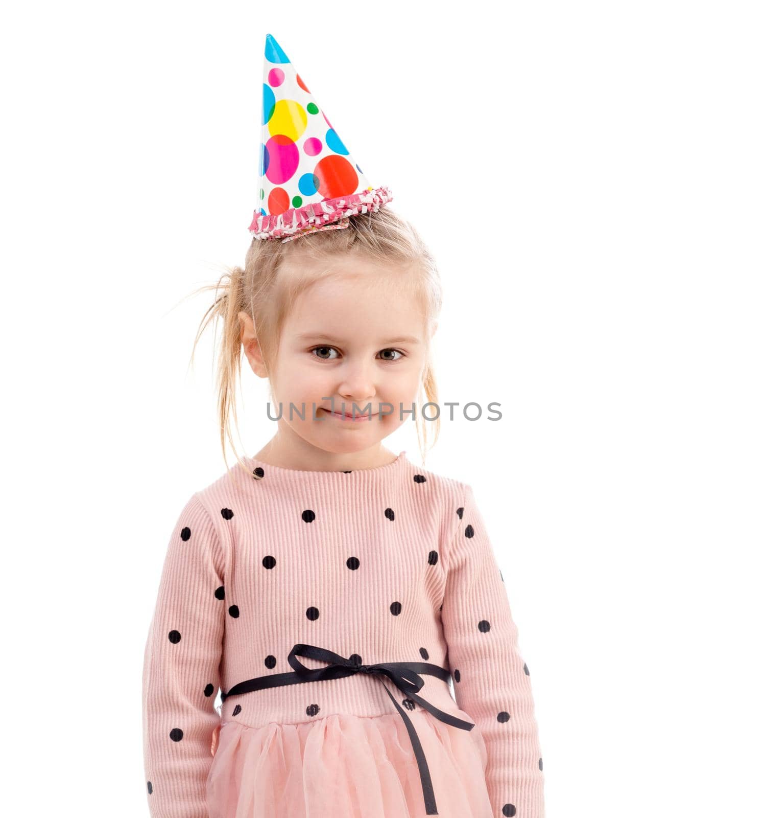 Girl's birthday, wearing a colorful birthday cap, polkadot sweatshirt, smiling happily, isolated on white background