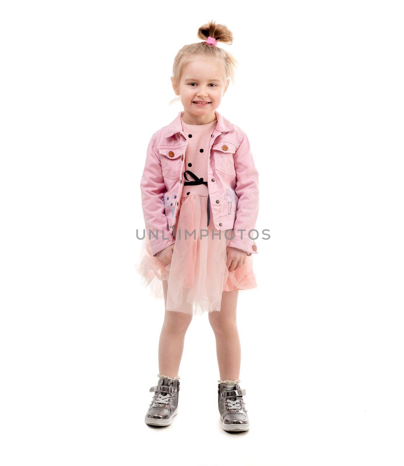 Amazing kid with lovely hairstyle moving around, turning and spinning, isolated, cute outfit
