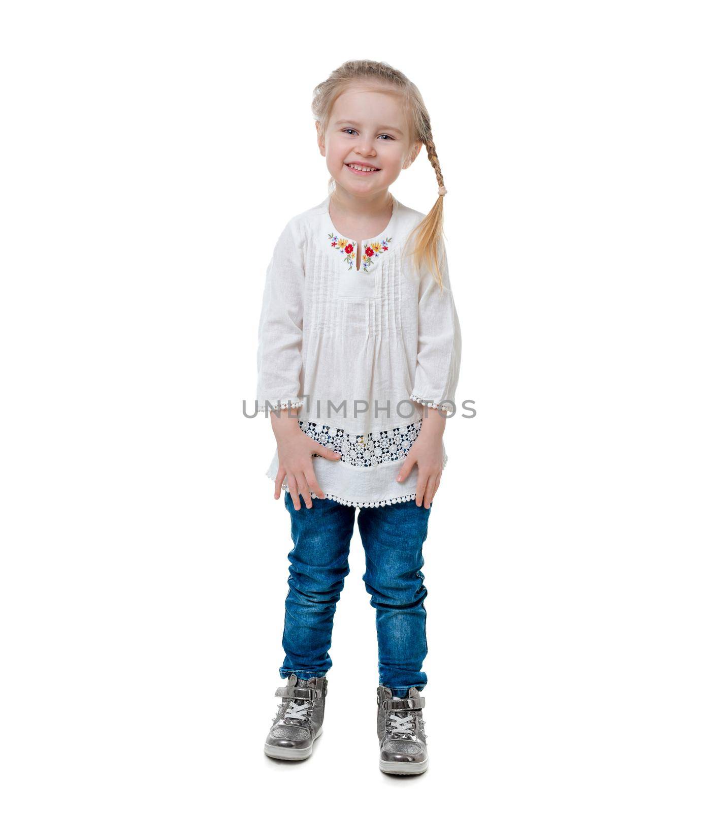 Nice little girl with beautiful hairstyle, wearing white embroidered shirt, isolated on white background