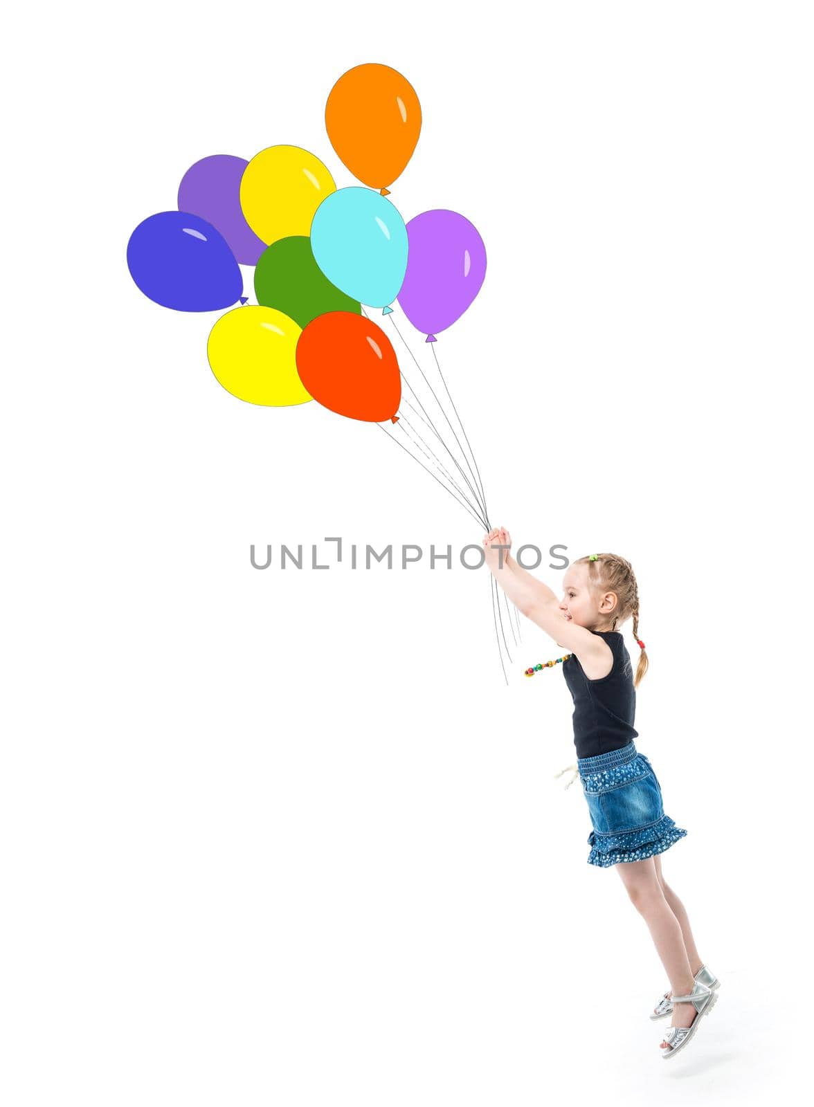 Cute little girl in lovely jeans skirt jumping up and reaching colorful balloons