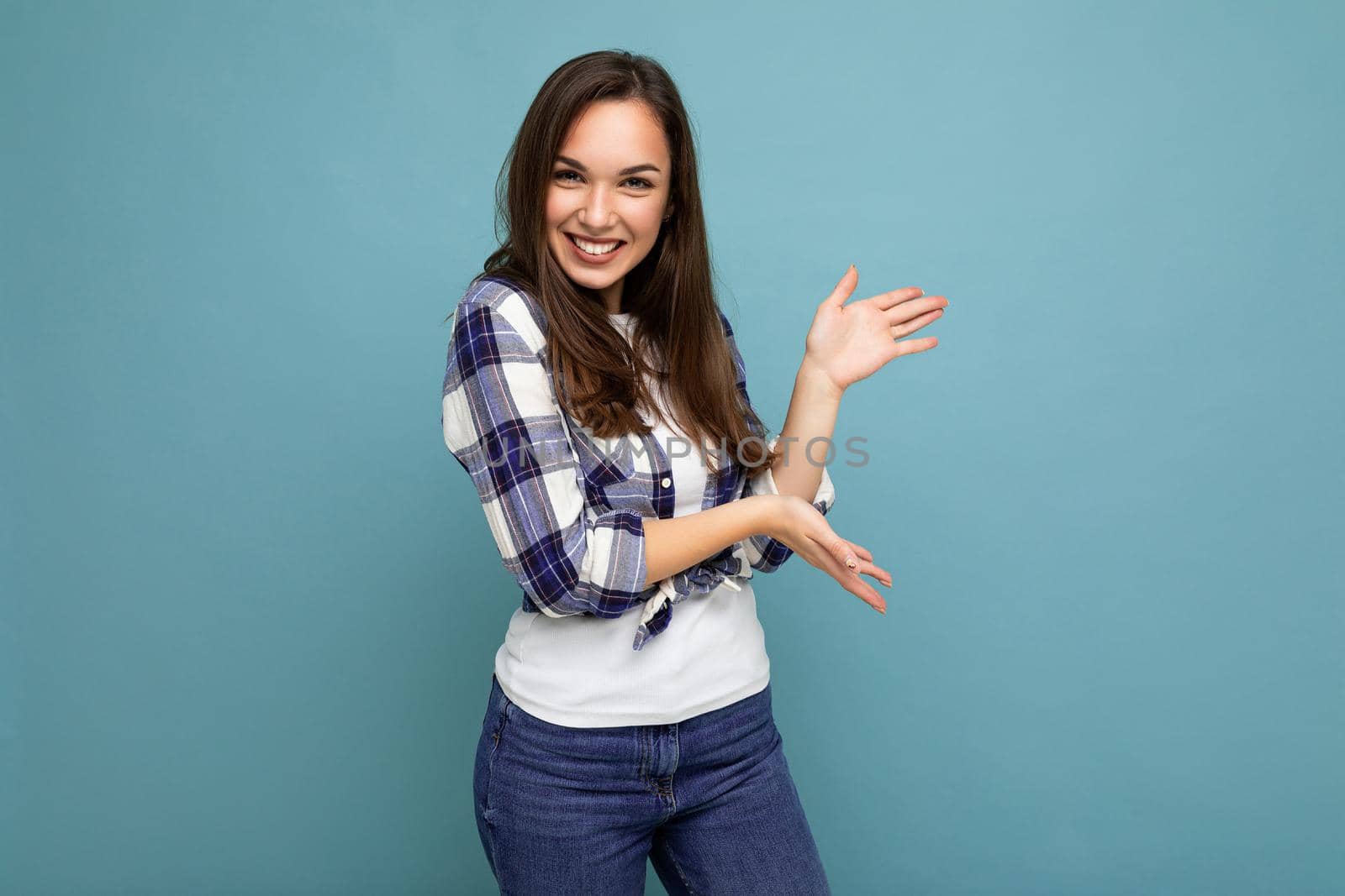 Close up photo of positive happy amazing cute nice charming young woman holding hands and showing advertisement wearing casual clothes isolated over background with copy space by TRMK