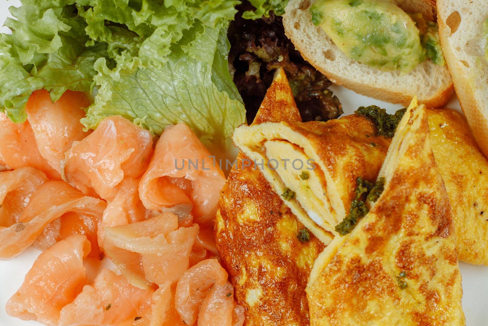 omelet with red fish and vegetables, beautiful serving.