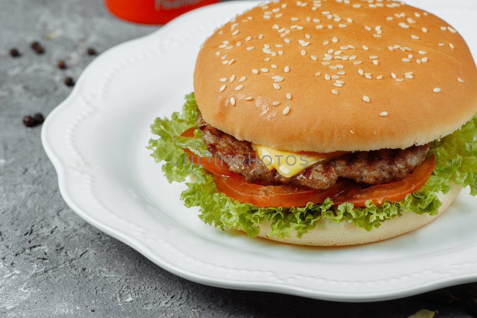 hamburger with fries and salad on the plate.