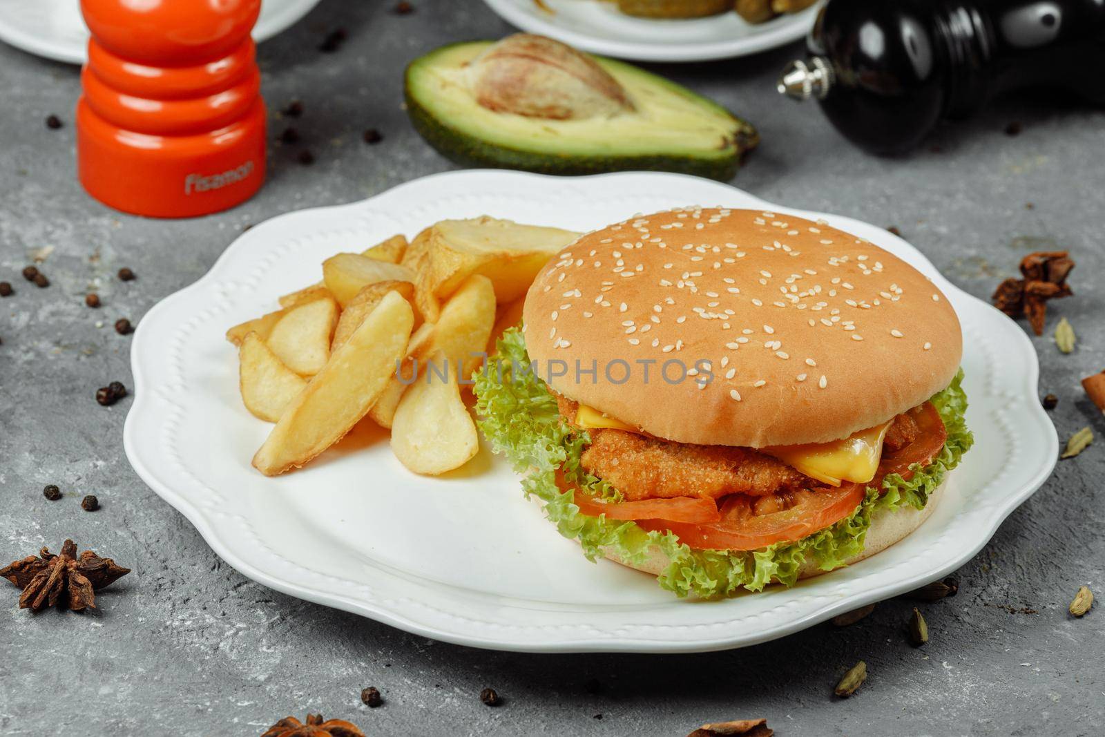 hamburger with fries and salad on the plate.