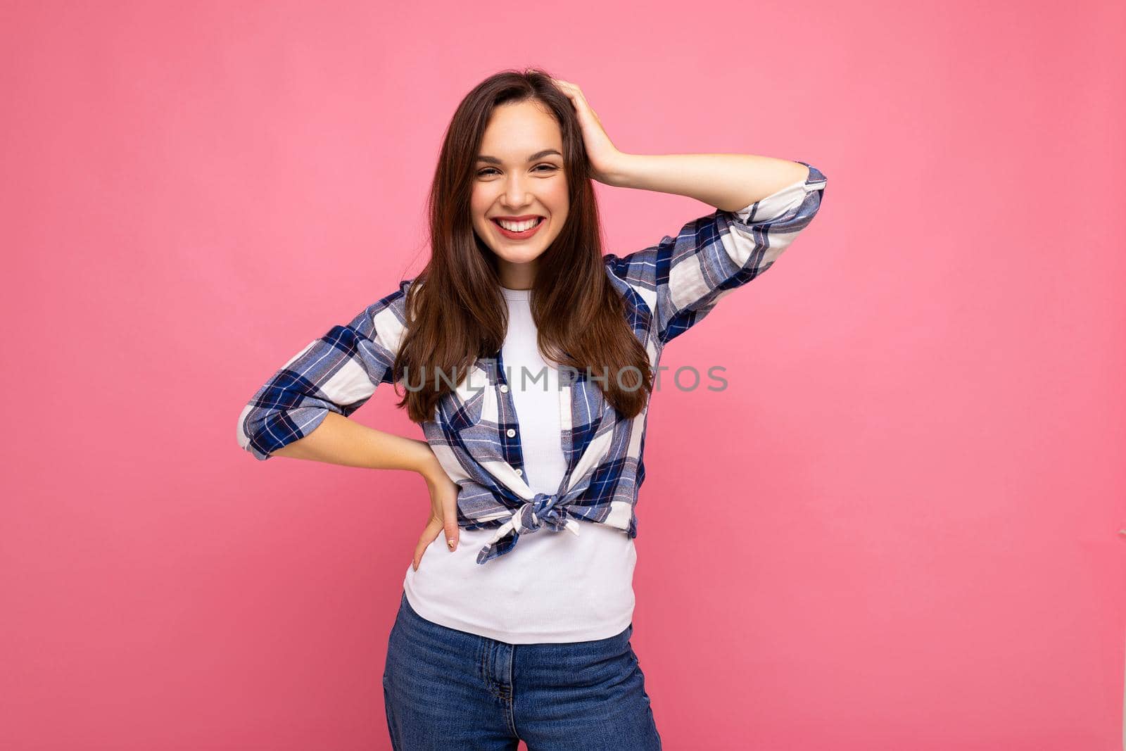 Portrait of positive cheerful fashionable woman in hipster outfit isolated on pink background with copy space.