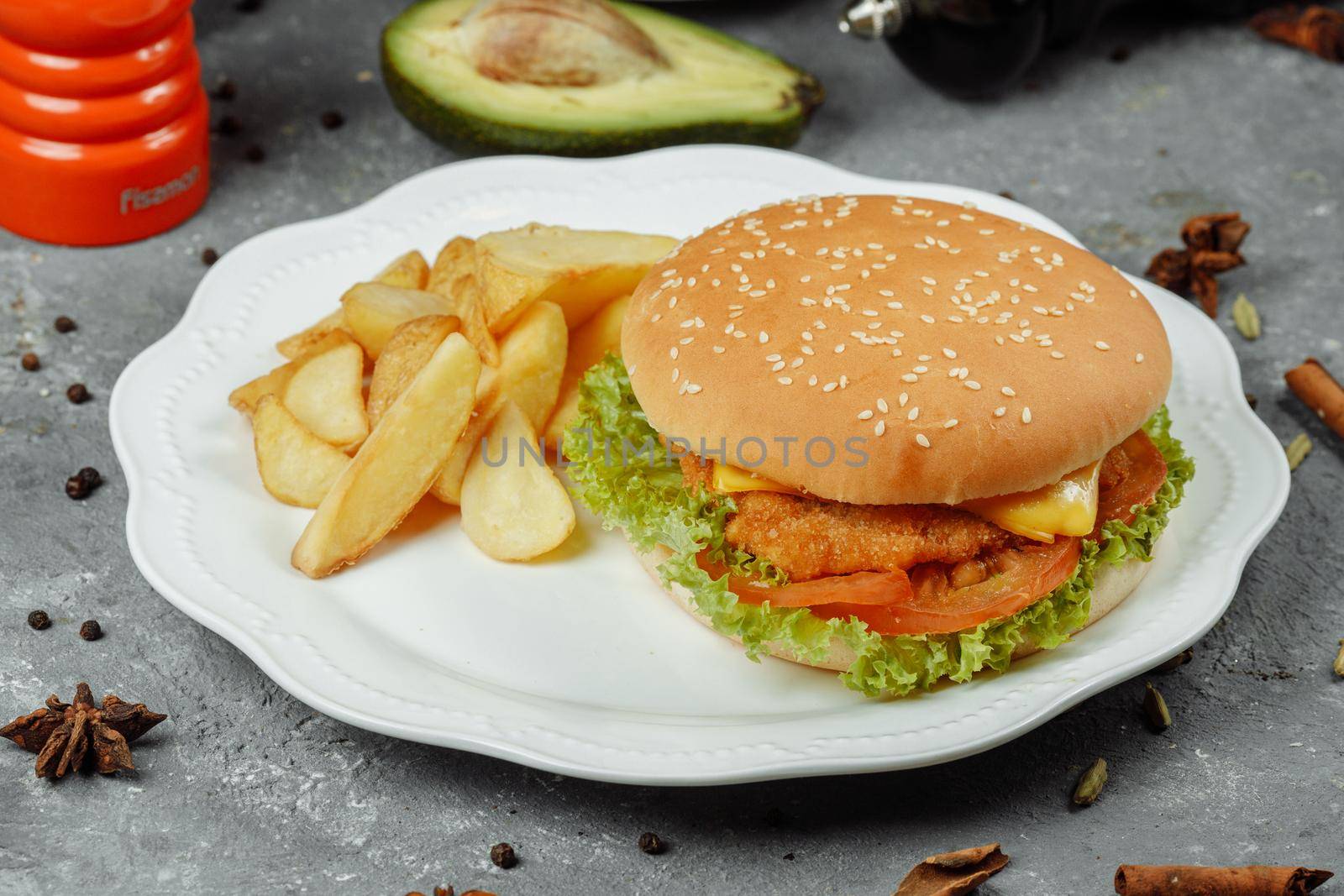 hamburger with fries and salad on the plate.