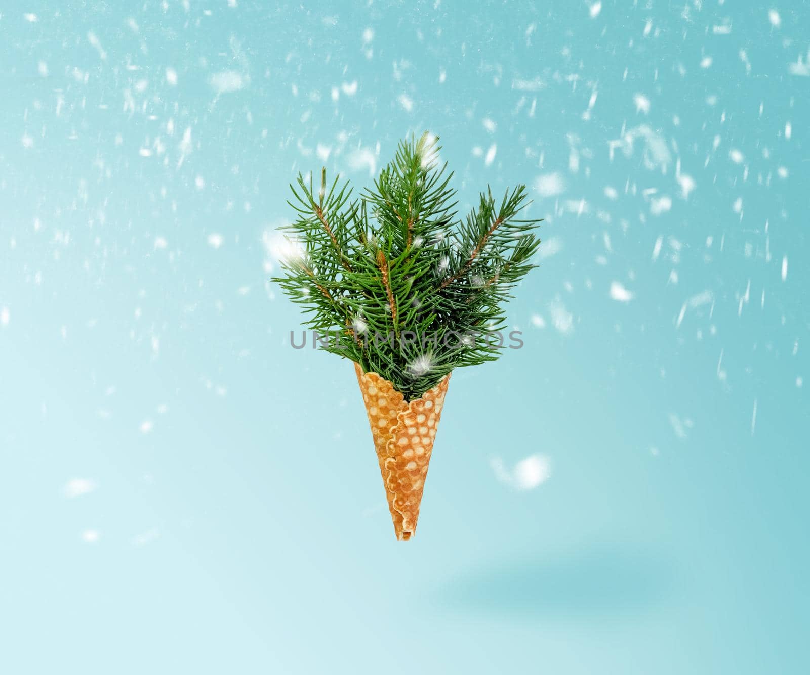 Christmas Tree Ice Cream Levitation in Snow on Ligth Background. New Year Concept. Minimal Holiday Composition. Copy Space.