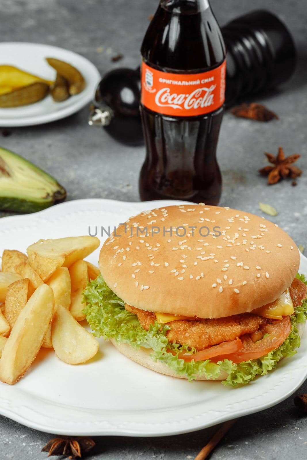 hamburger with fries and salad on the plate.