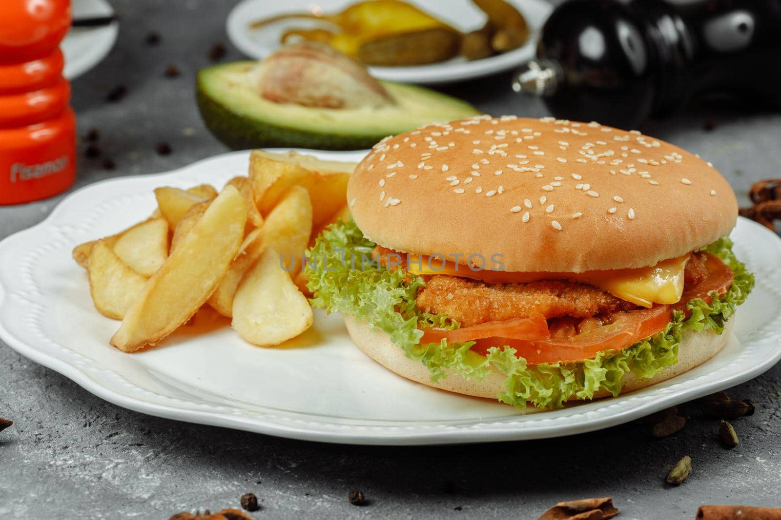 hamburger with fries and salad on the plate.