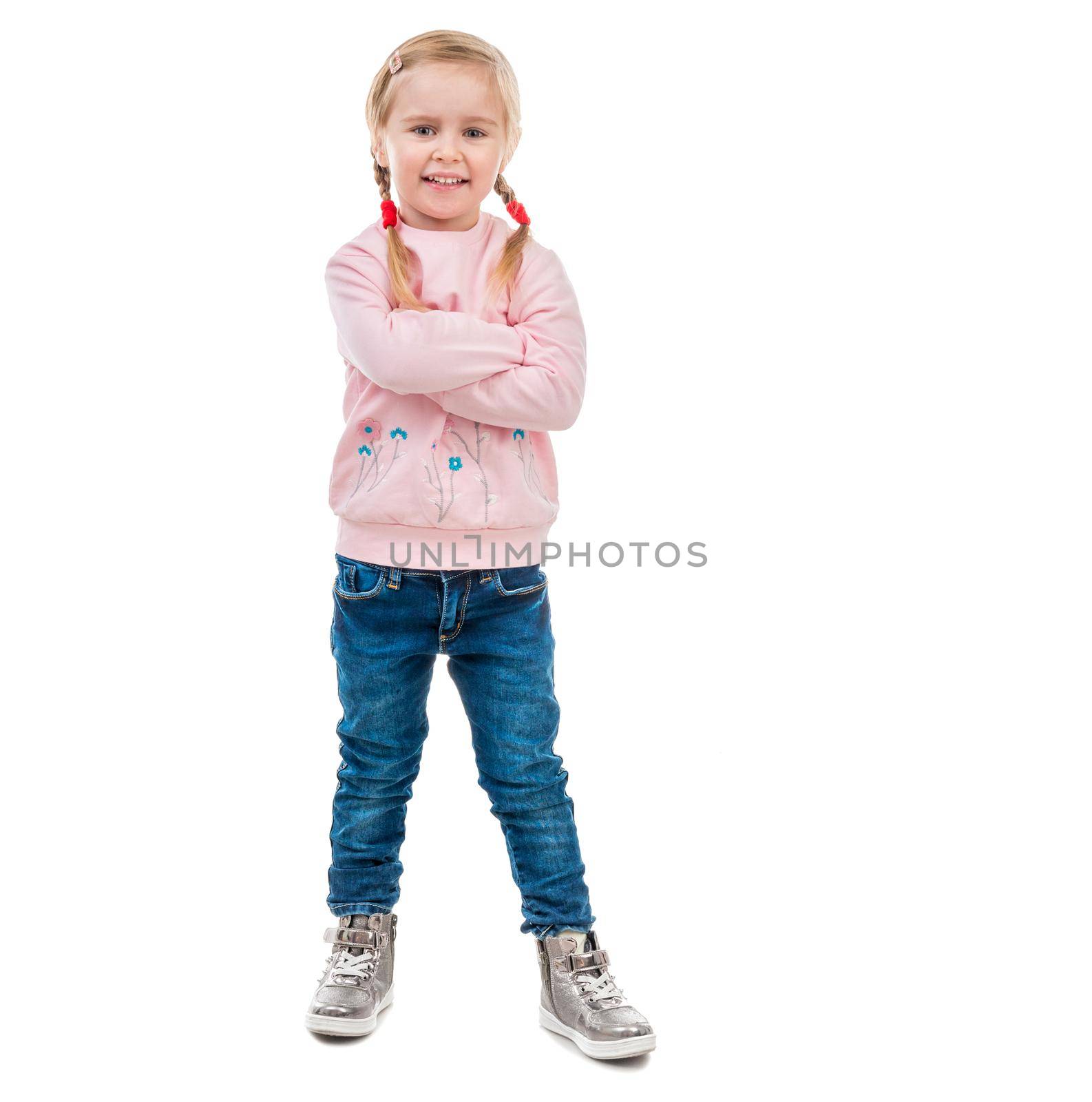 cute little girl with her hands in pockets, isolated on white background