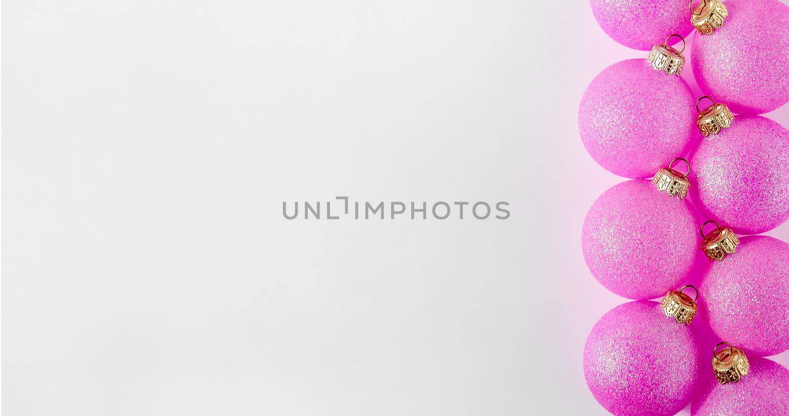 Christmas Pink Ball on Light Background. Minimal New Year Holiday Composition. Banner. Flat Lay. Copy Space.