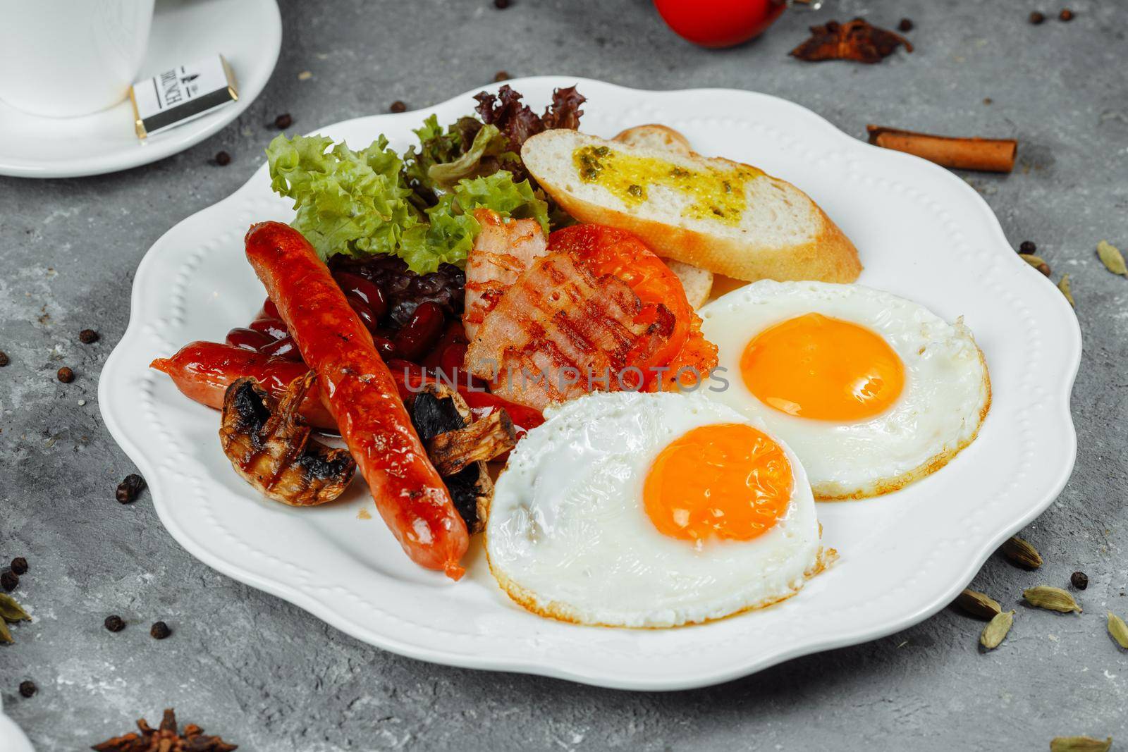 Fried breakfast with bacon, sausages and baked beans by UcheaD