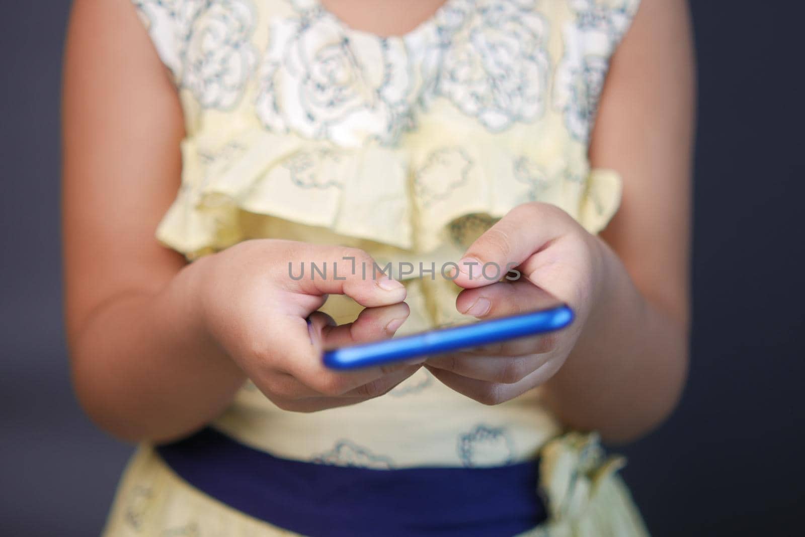 child hand pointing finger on smart phone screen