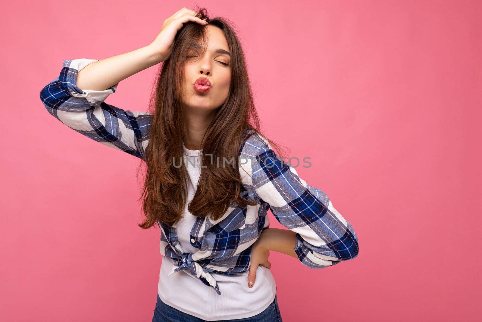 Photo shot of cute nice charming gorgeous attractive pretty youngster happy woman wearing stylish clothes isolated over colorful background with copy space and giving kiss.