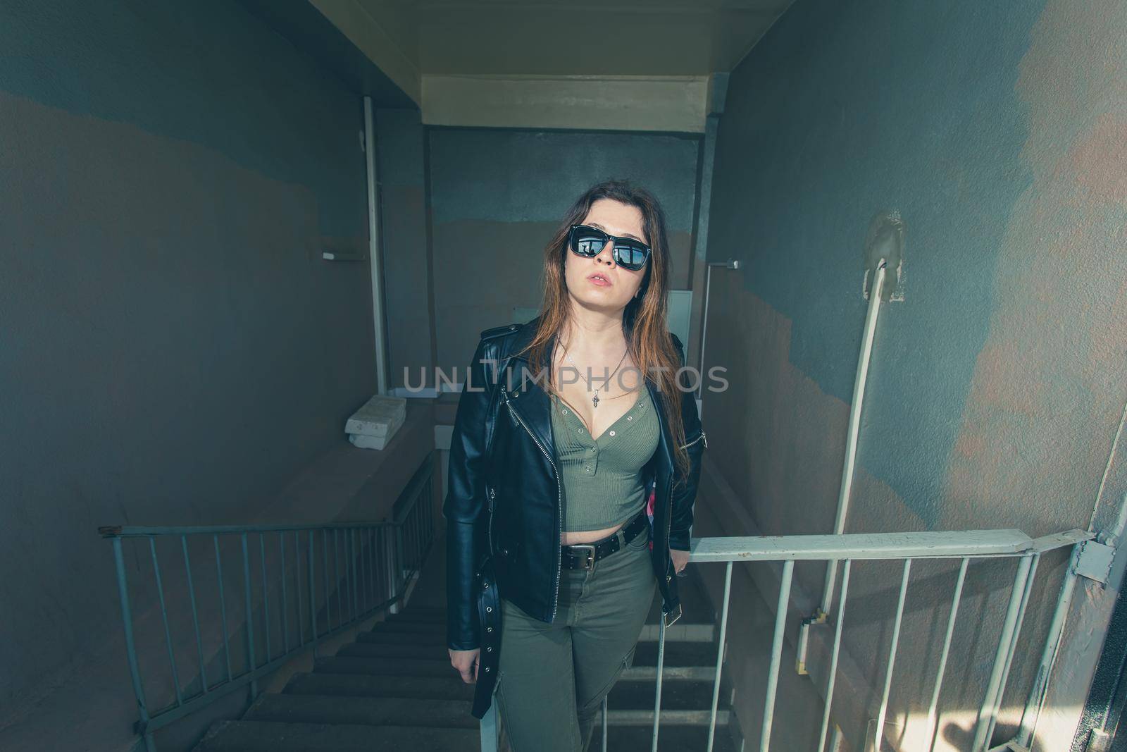 Women independence and feminism concept - Girl on dark stairs in military style