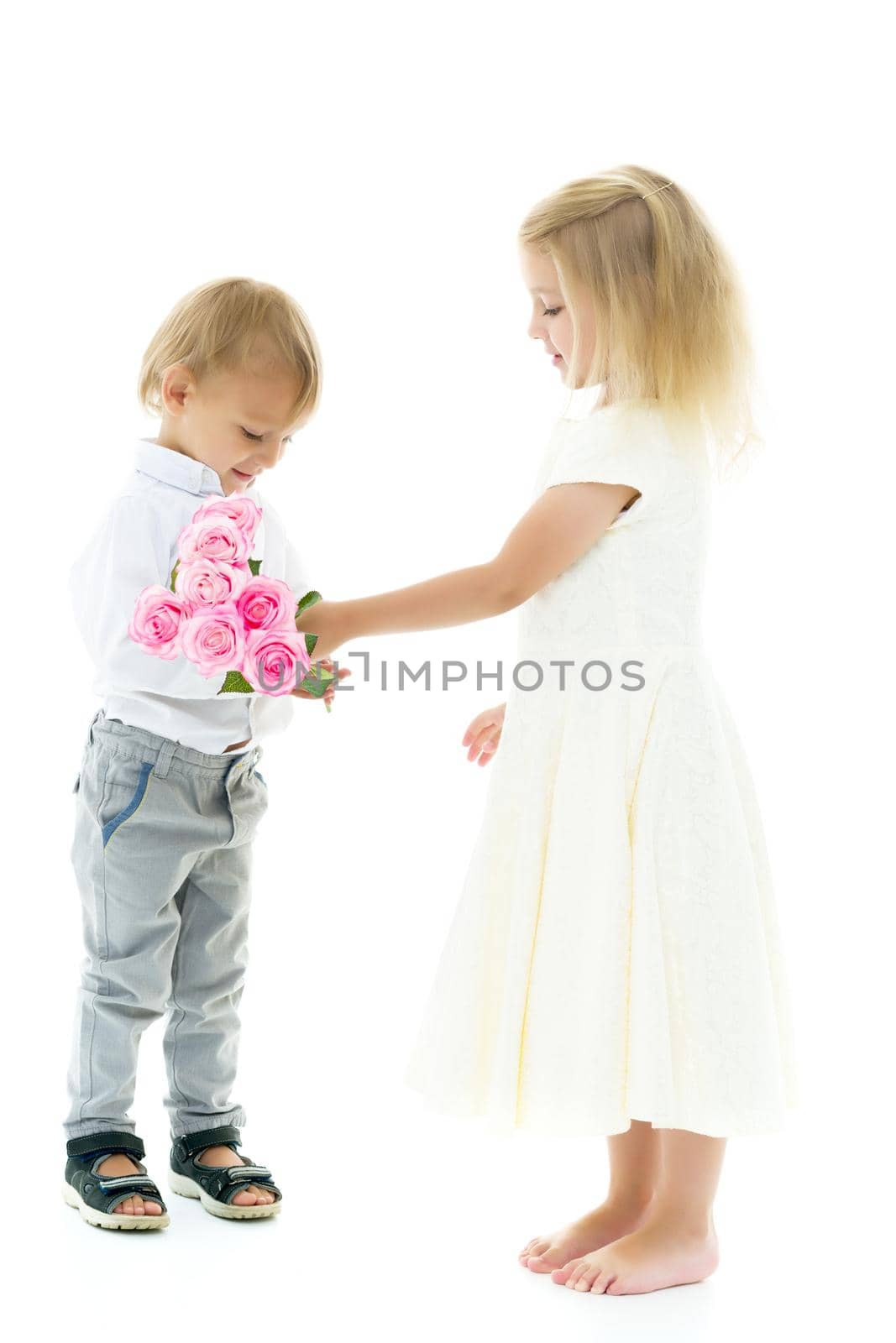A little boy gives a girl a bouquet of flowers for his birthday. The concept of love, family values. Isolated on white background