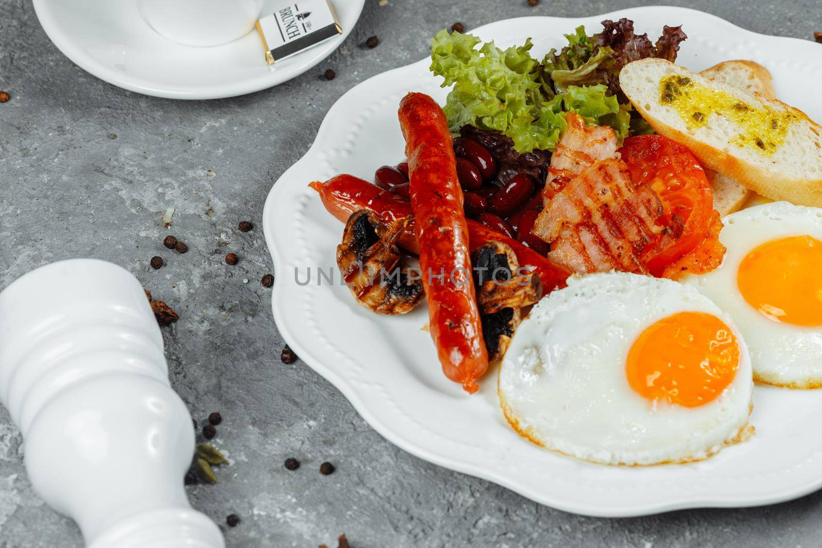 Fried breakfast with bacon, sausages and baked beans.