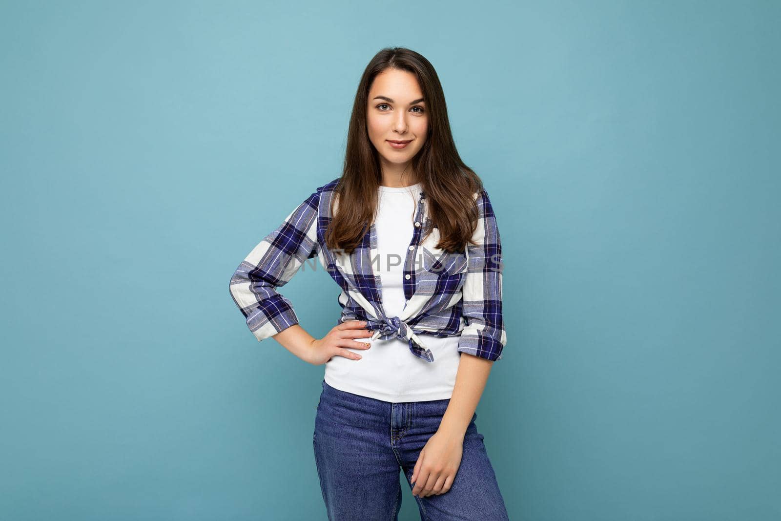 Portrait of positive cheerful fashionable woman in hipster outfit isolated on blue background with copy space.