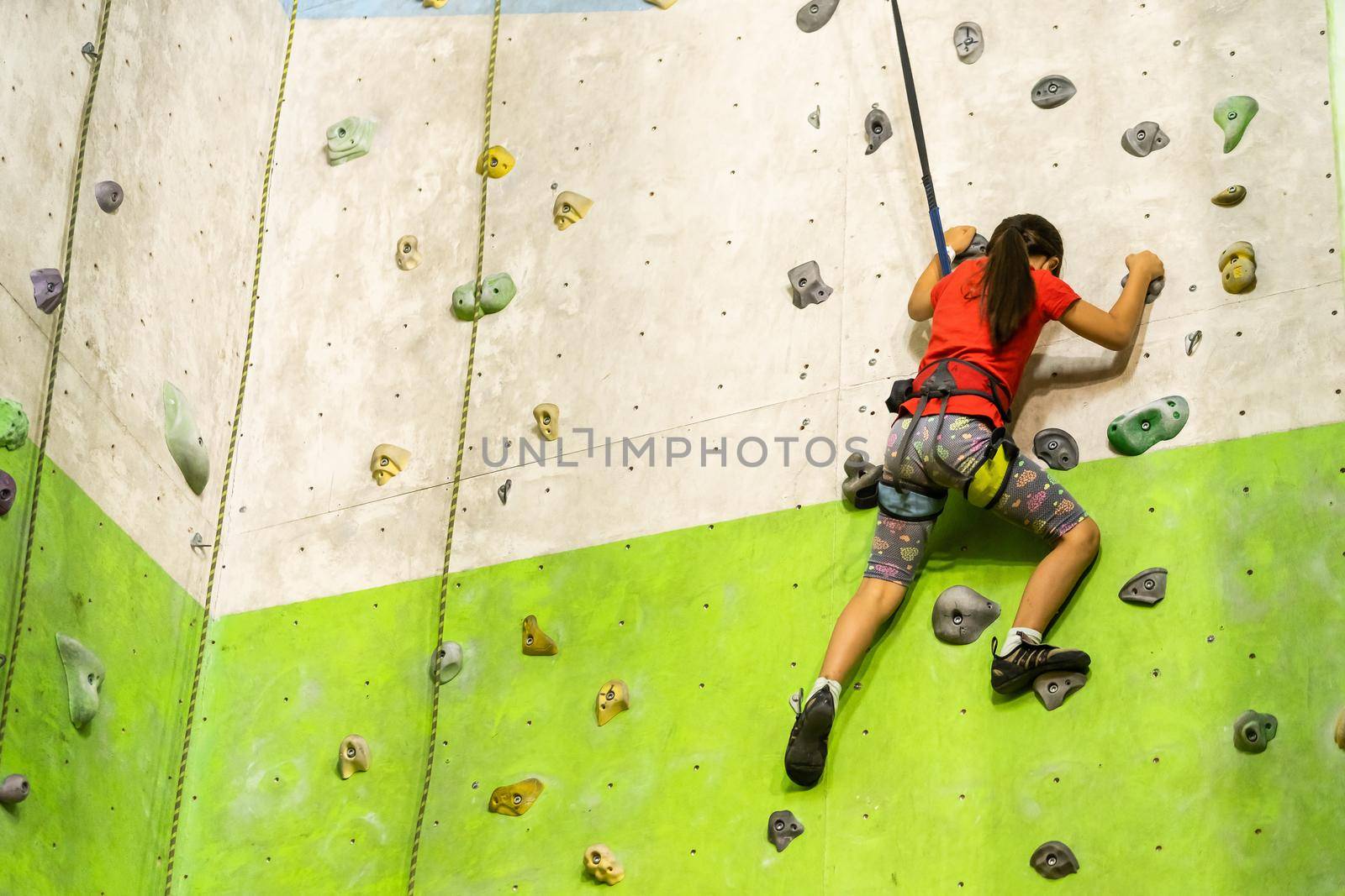 Little Girl Climbing Rock Wall
