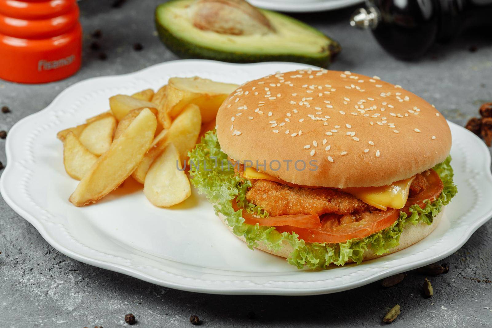 hamburger with fries and salad on the plate.