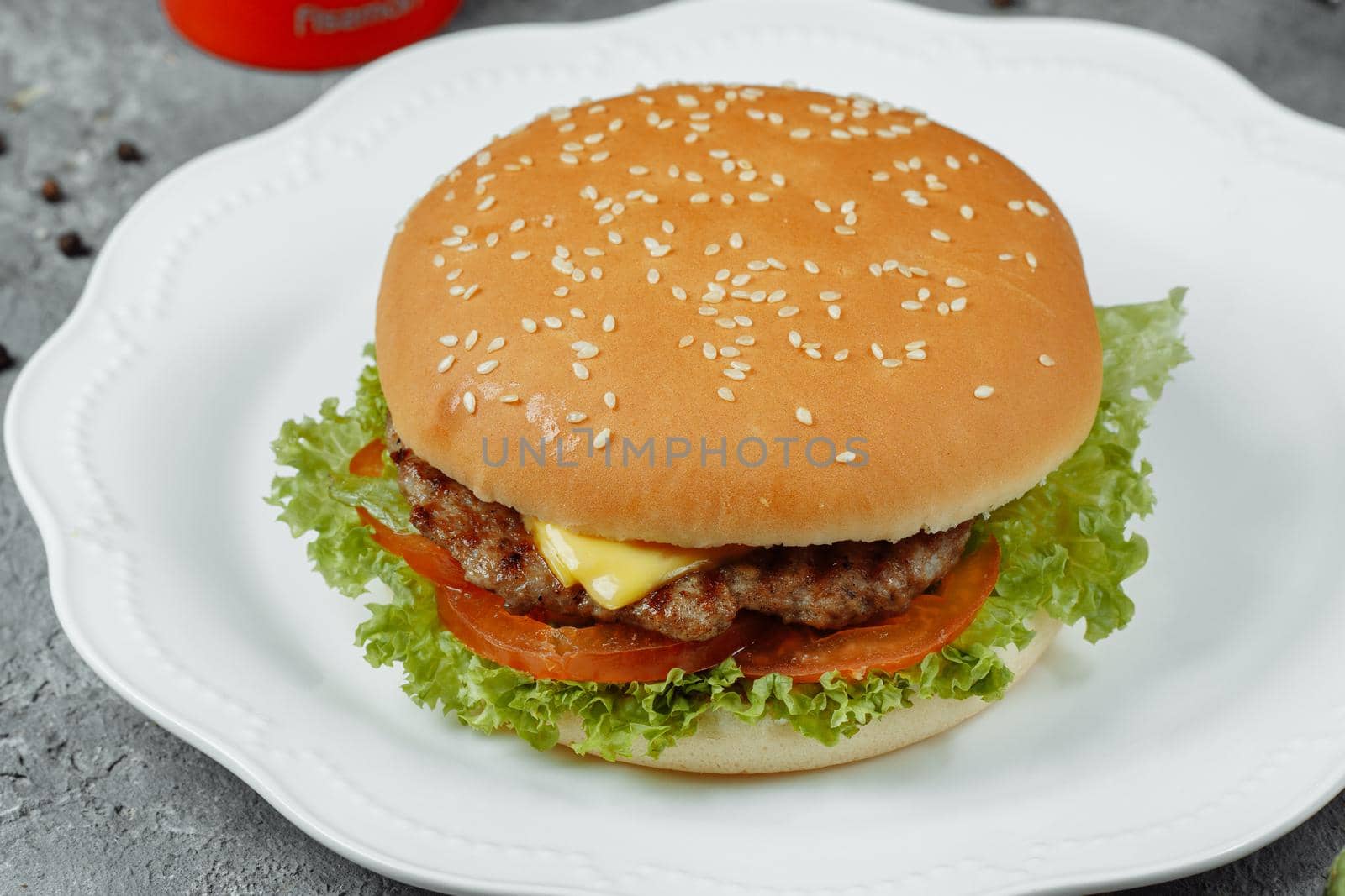 hamburger with fries and salad on the plate.