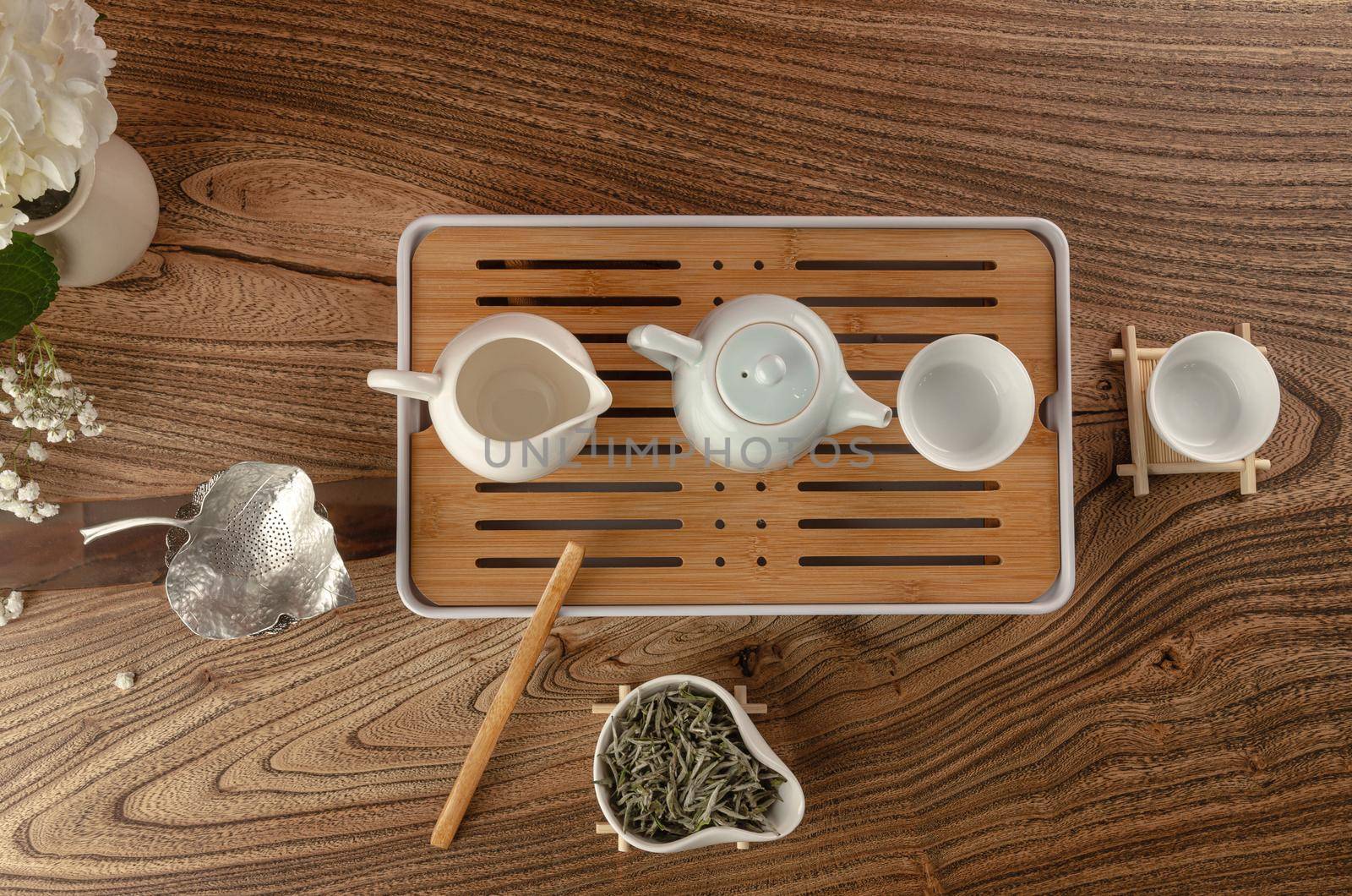 tea table with instruments teapots cups and green tea