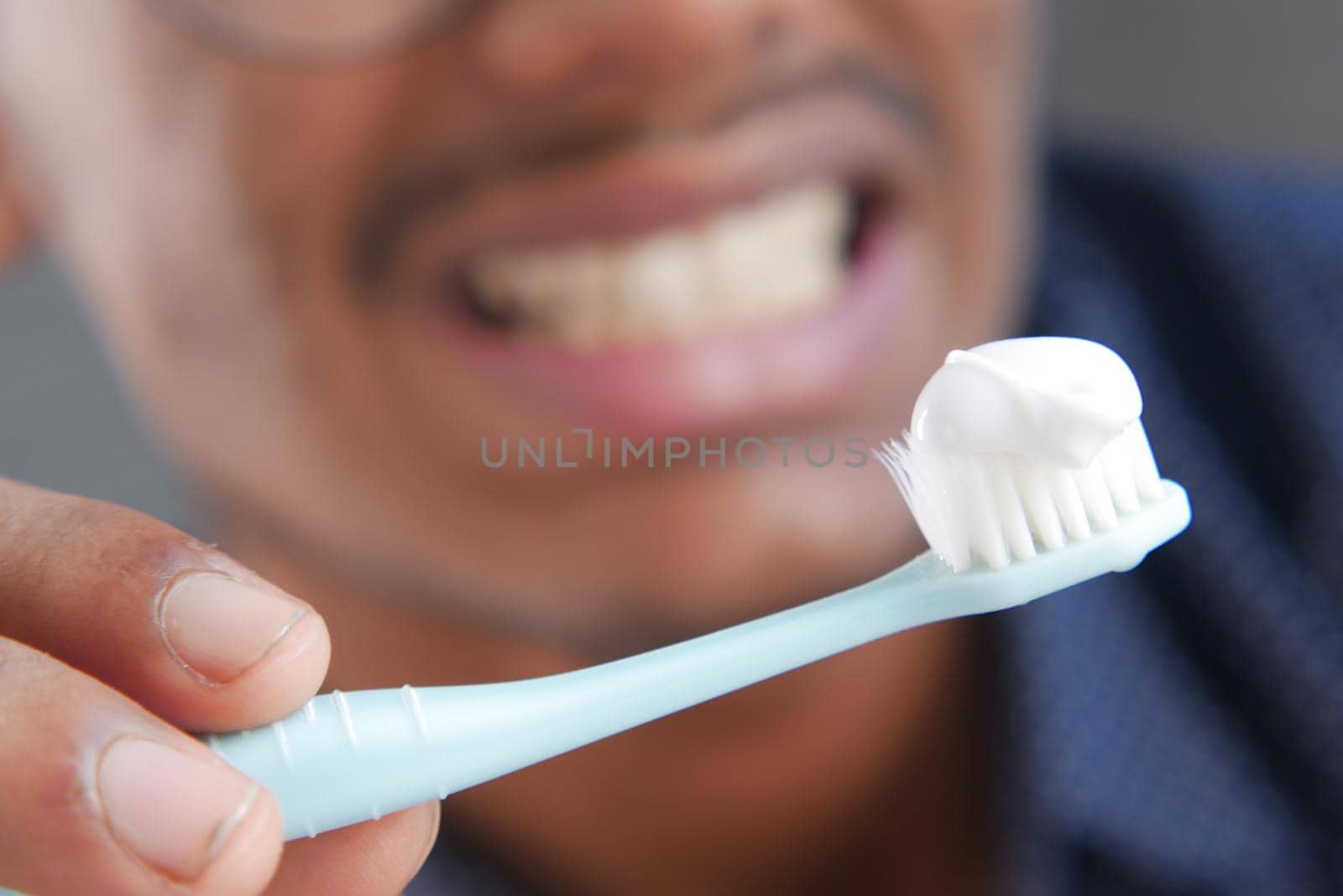 detail shot of young man brushing teeth