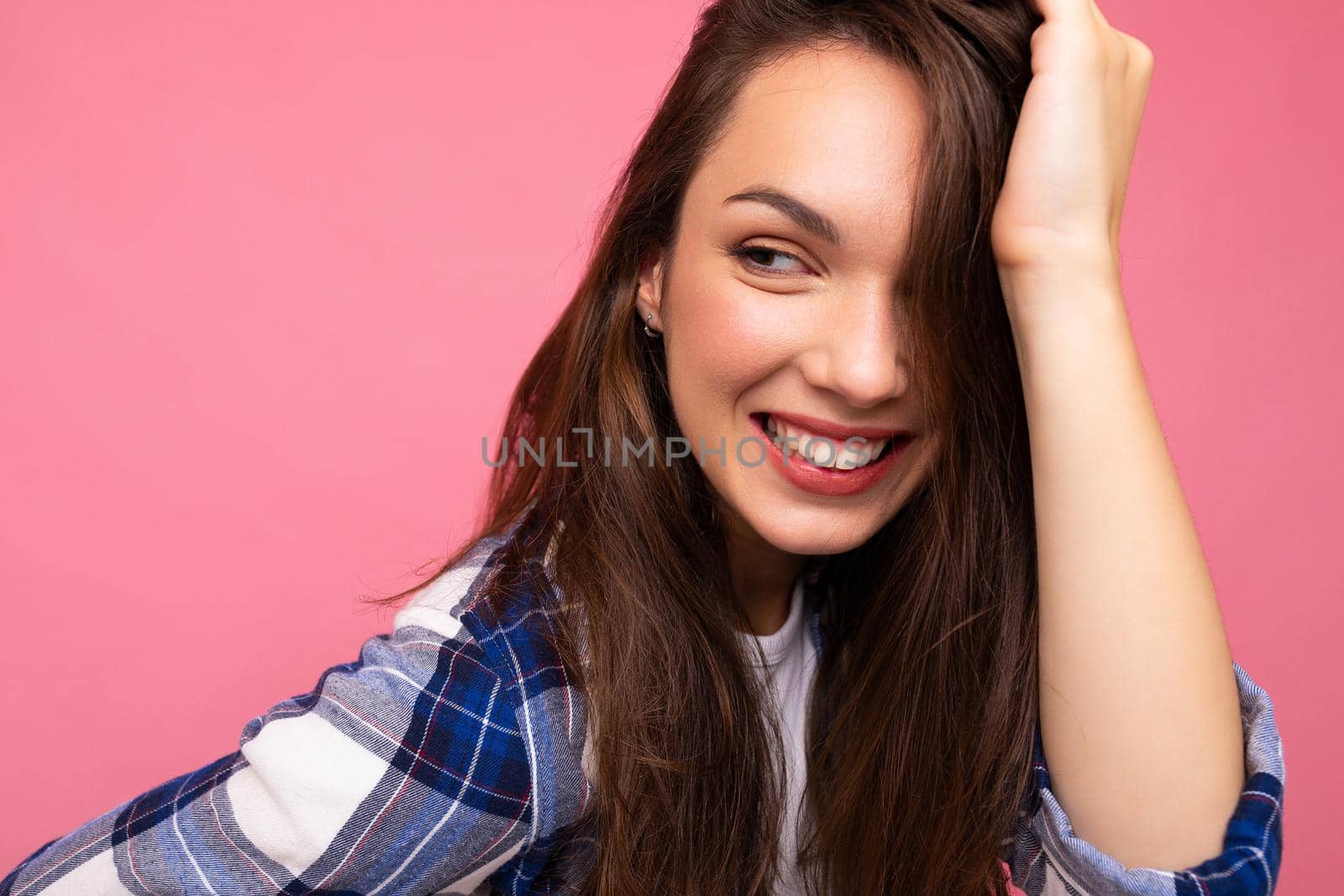 Portrait of positive cheerful fashionable woman in hipster outfit isolated on pink background with copy space.