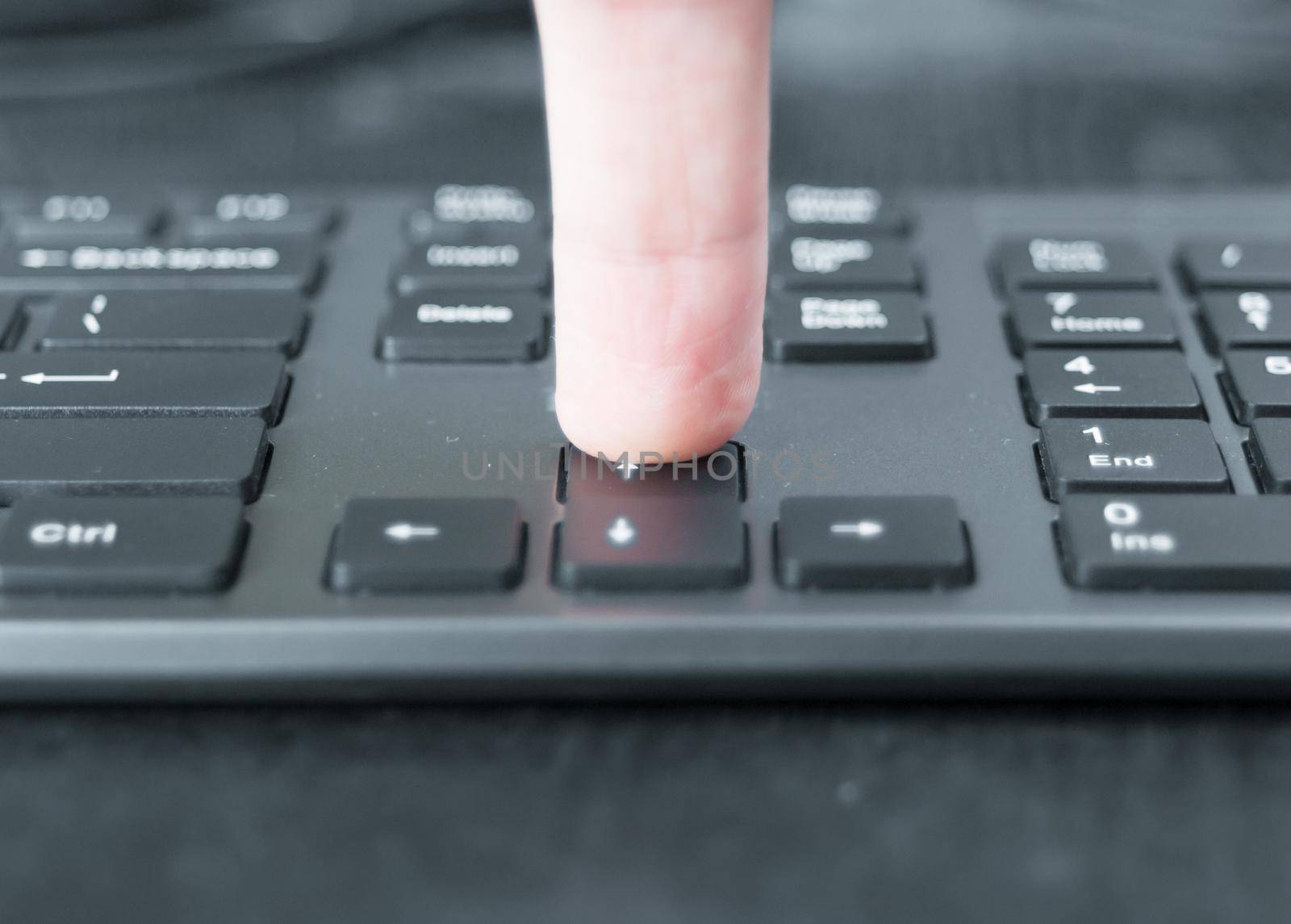 Pressing the keyboard closeup. Black keyboard on the desk