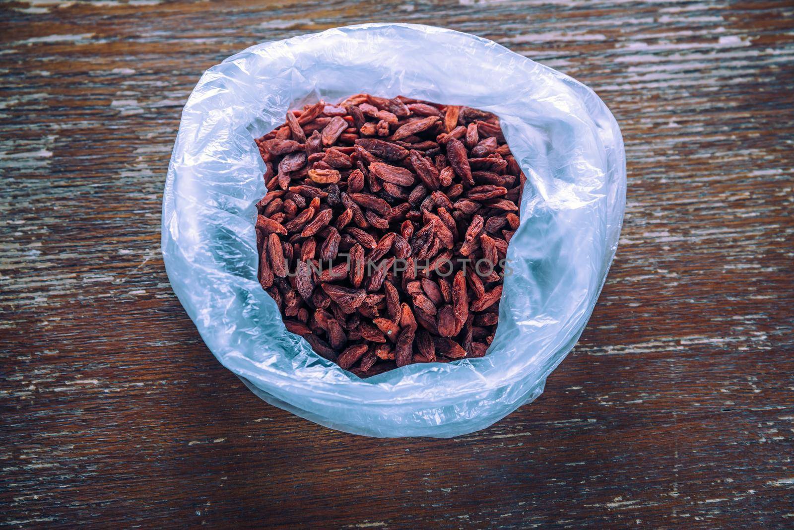 Goji berries in the bag on a wooden table